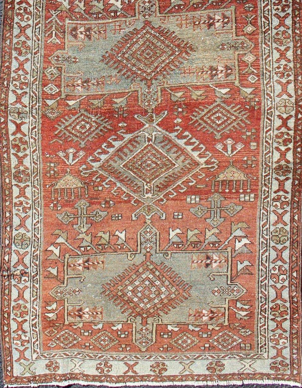 Sub-geometric Medallion design Persian Heriz antique runner in red and gray-blue tones, rug gng-4750, country of origin / type: Iran / Heriz, circa 1920

This antique Persian Heriz runner, from northwest Iran, displays a geometric medallion design