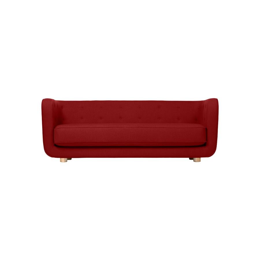 Red and natural oak Raf Simons Vidar 3 Vilhelm sofa by Lassen
Dimensions: W 217 x D 88 x H 80 cm 
Materials: textile, oak.

Vilhelm is a beautiful padded three-seater sofa designed by Flemming Lassen in 1935. A sofa must be able to function in