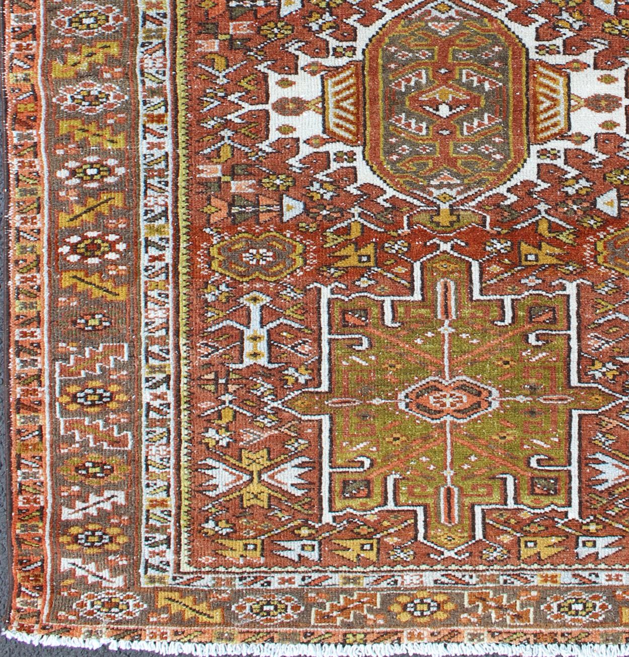 Geometric layered Medallion design antique Karadjeh rug from Persia in rust red and olive and sharp yellow green colors, rug gng-4736, country of origin / type: Iran / Karadjeh, circa 1920

This early 20th century, handwoven antique Persian Karadjeh
