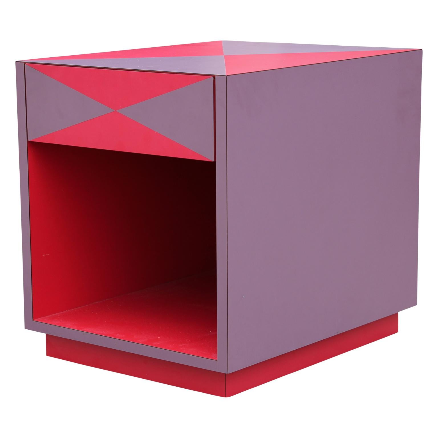 Purple and red Memphis style side table with open storage compartment and pull out drawer.