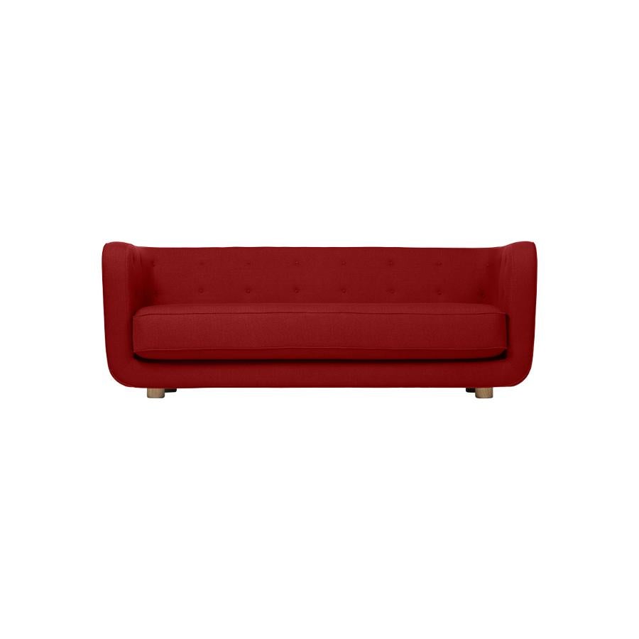 Red and smoked Oak Raf Simons Vidar 3 Vilhelm sofa by Lassen
Dimensions: W 217 x D 88 x H 80 cm 
Materials: Textile, Oak.

Vilhelm is a beautiful padded 3-seater sofa designed by Flemming Lassen in 1935. A sofa must be able to function in