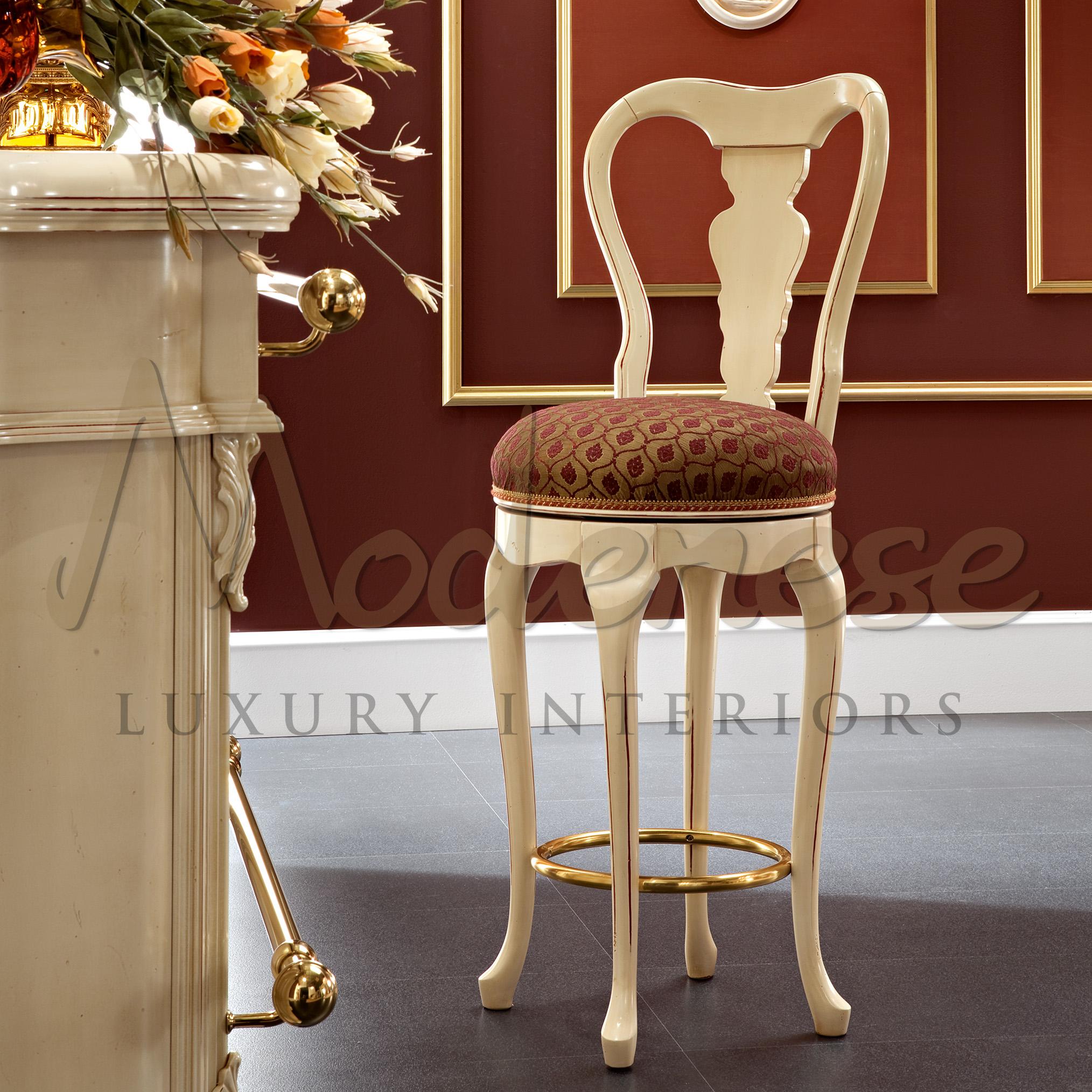 Elegant victorian bar stool in bright ivory finish and antiqued polishing with red satin upholstery and golden metal round frame. This seating element, which pairs with the Modenese Home Bar set (featuring a bar counter and chairs), is thoughtfully