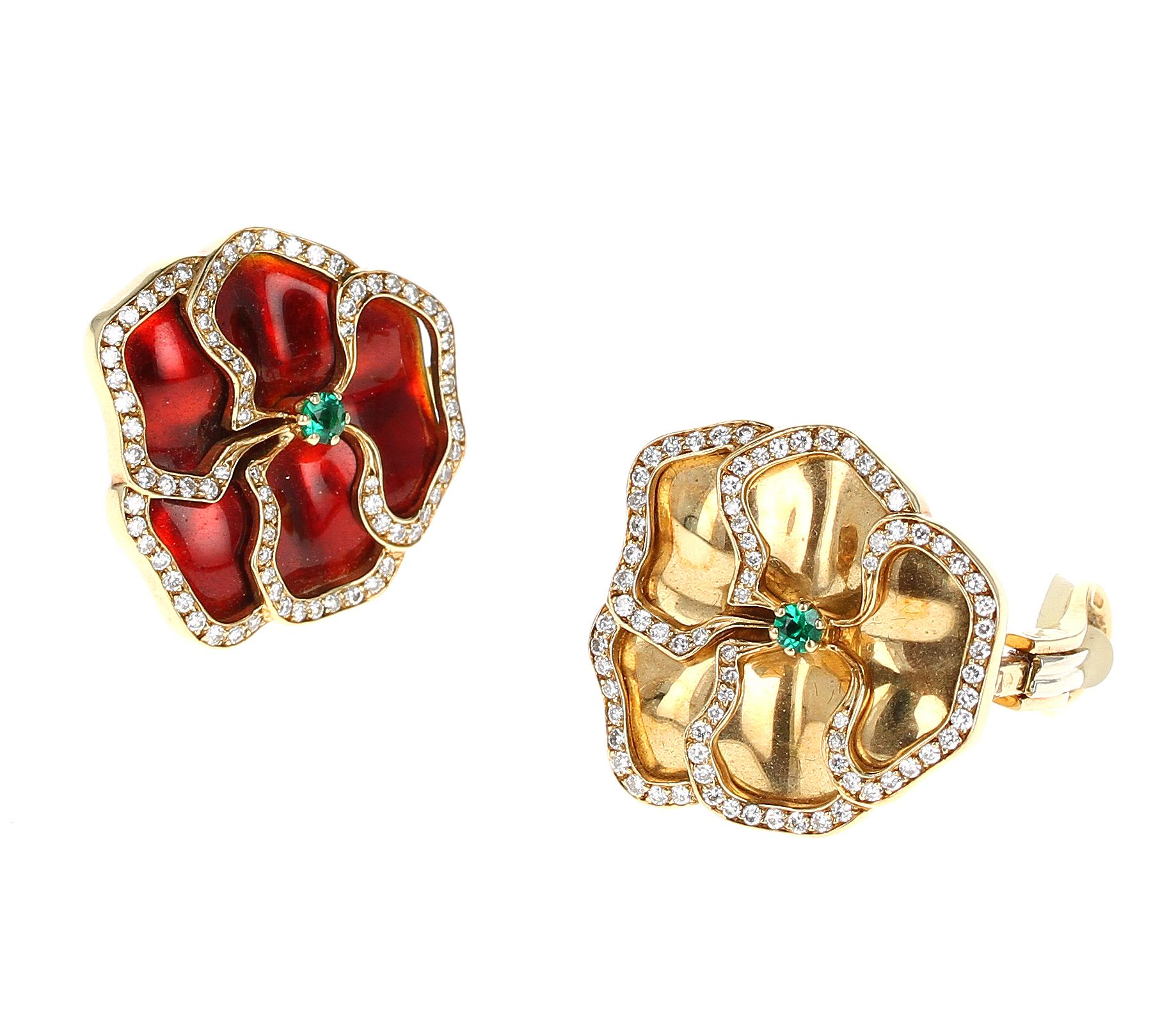 A stylish asymmetrical floral pair of enameled earrings- one red and one yellow with yellow gold. The center of the flower is an emerald cut stone and the leaves are outlined with diamonds. 