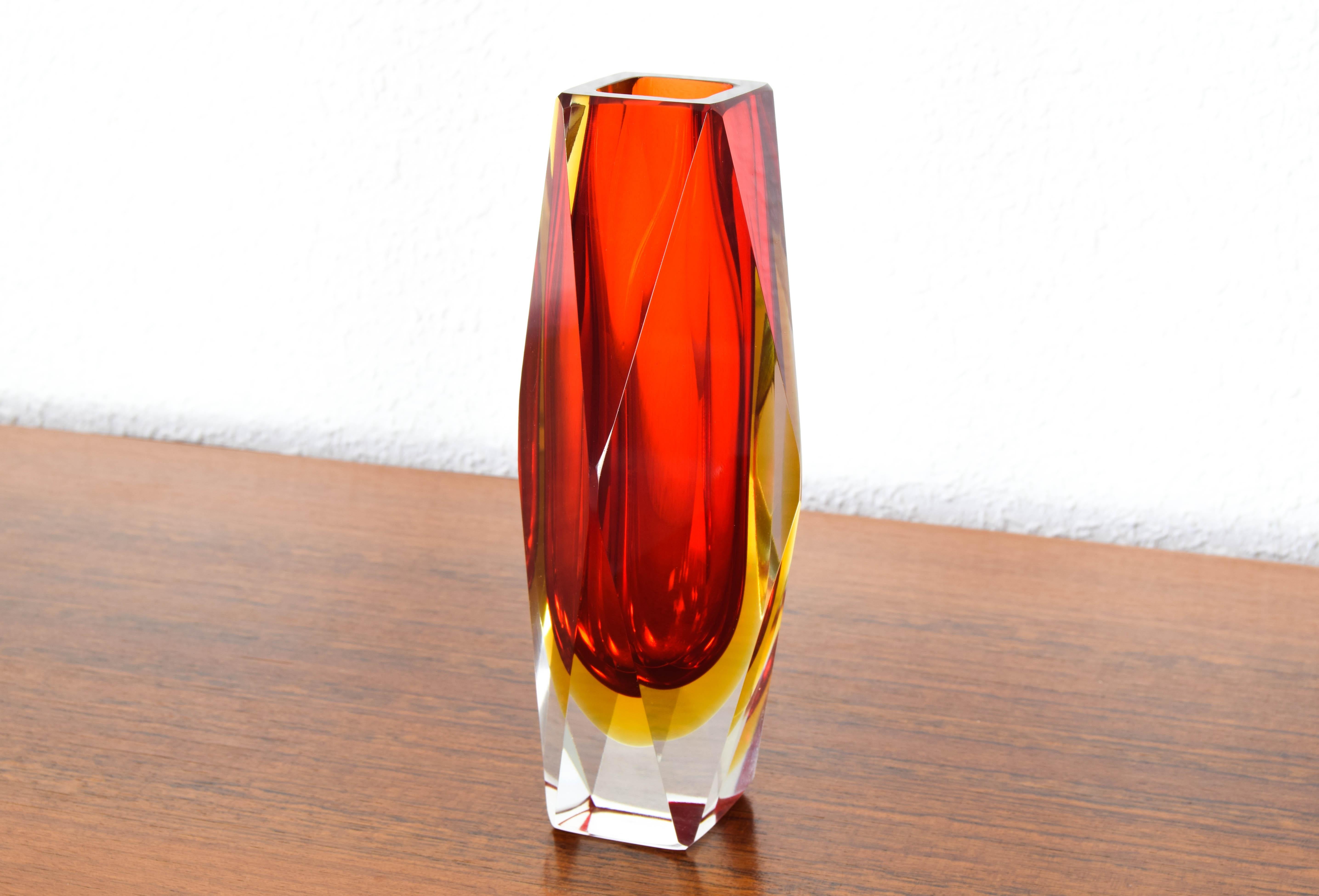 Beautiful Italian Murano glass vase blown with Sommerso technique designed by Alessandro Mandruzzato and produced in the early 60s.
Striking and bright colors, it is made up of a bright red inner layer, a yellow middle layer and a transparent outer