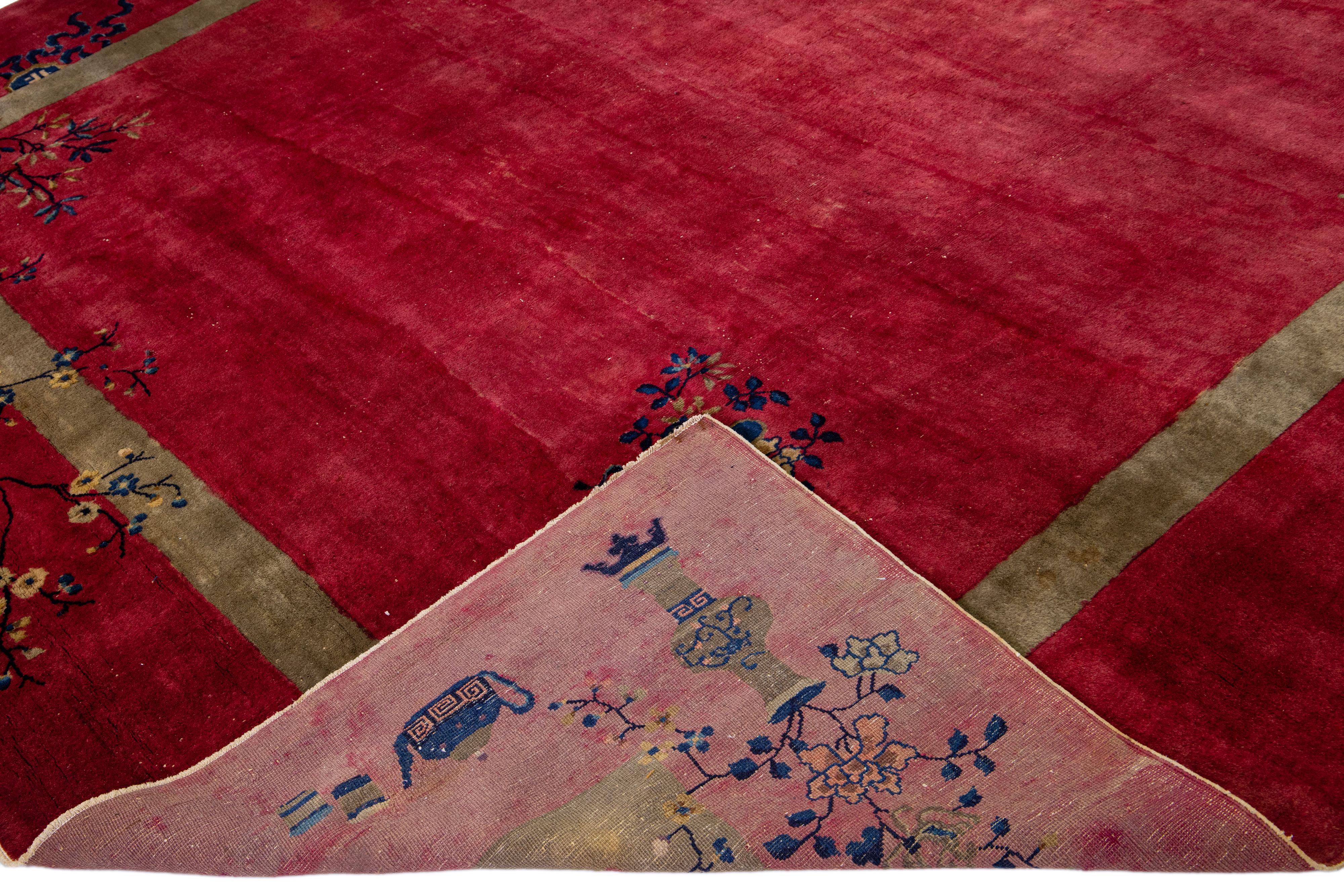 Beautiful antique Art Deco hand-knotted wool rug with a red field. This Chinese rug has multicolor accent colors with a gorgeous all-over Chinese floral design. 

This rug measures: 10'10