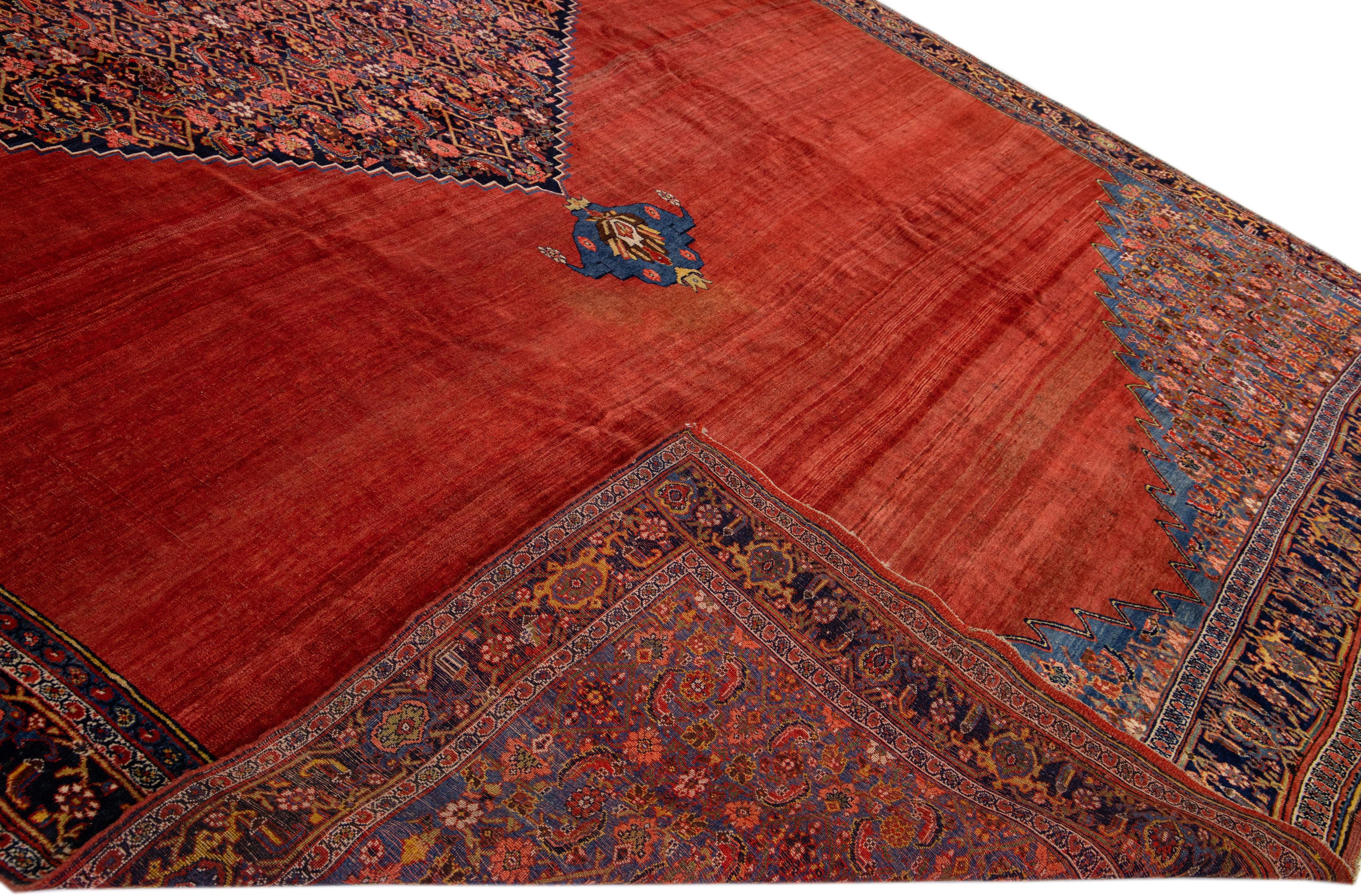 Beautiful antique Bidjar hand-knotted wool rug with a red field. This Persian rug has multicolor accents in an all-over center medallion design.

This rug measures: 11'9