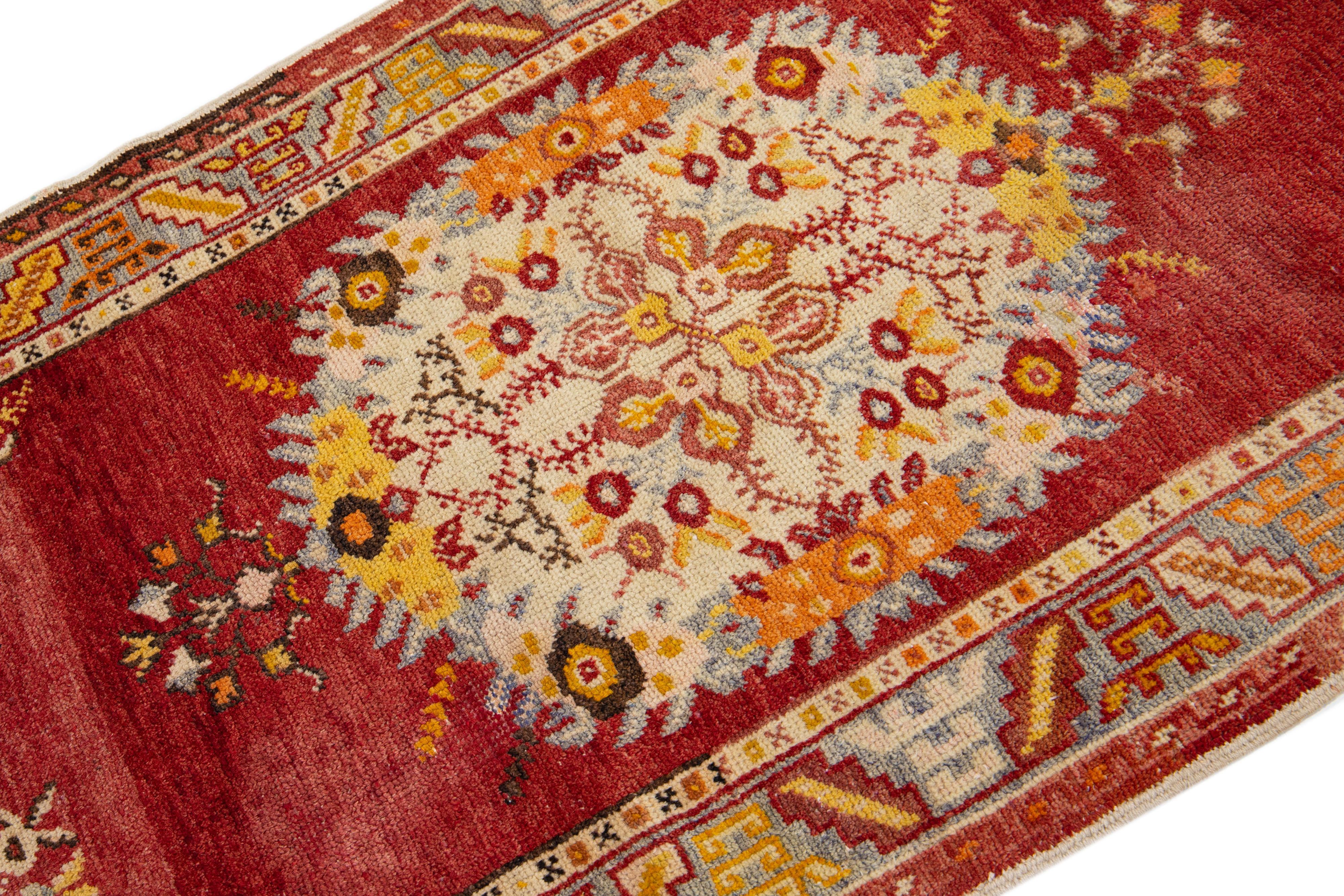 East Turkestani Red Antique Handmade Khotan Wool Rug with Medallion Motif For Sale