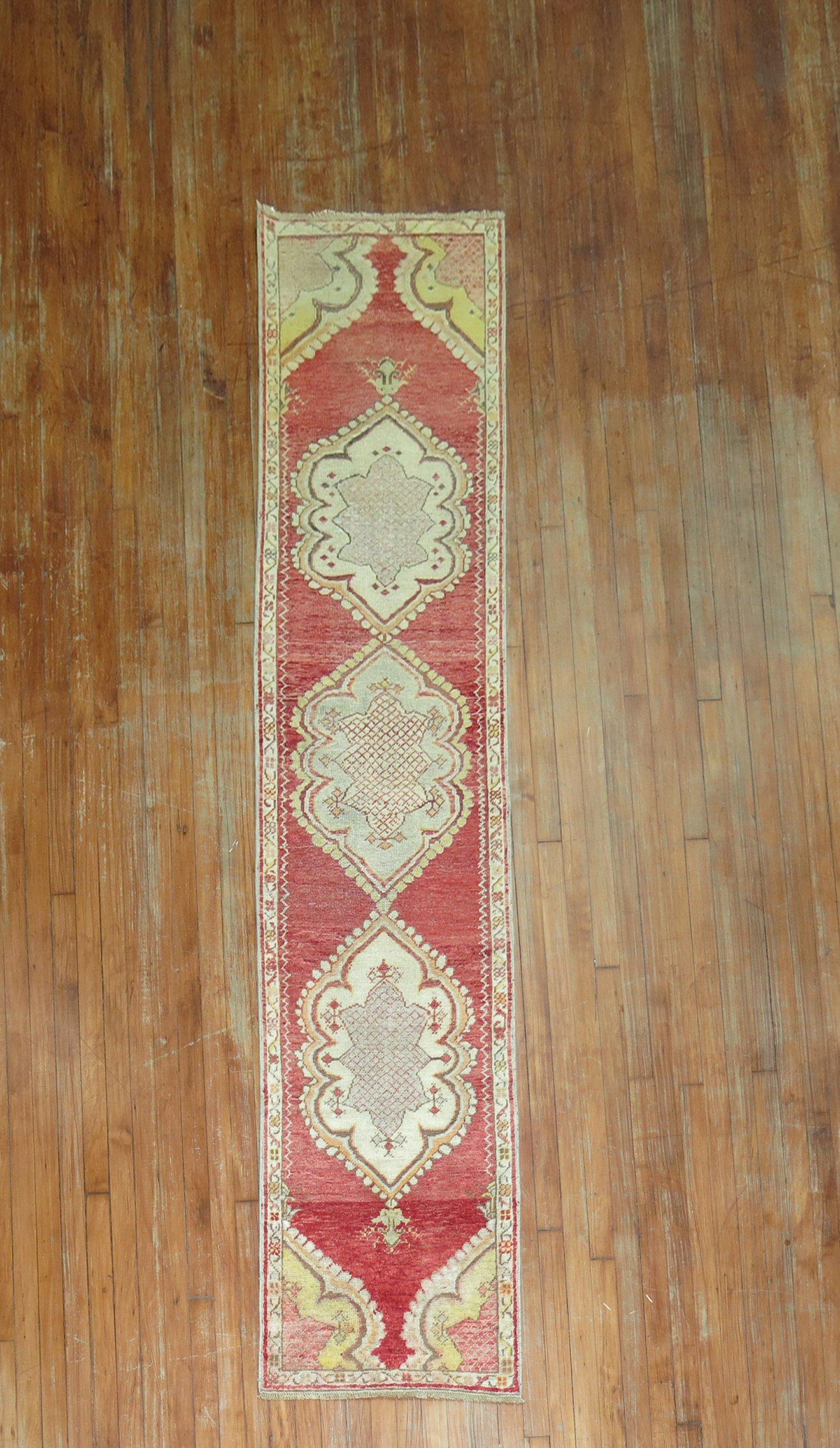 A lovely Turkish runner from the middle of the 20th century with a floral motif on a red field

Measures: 2'x 8'9''.