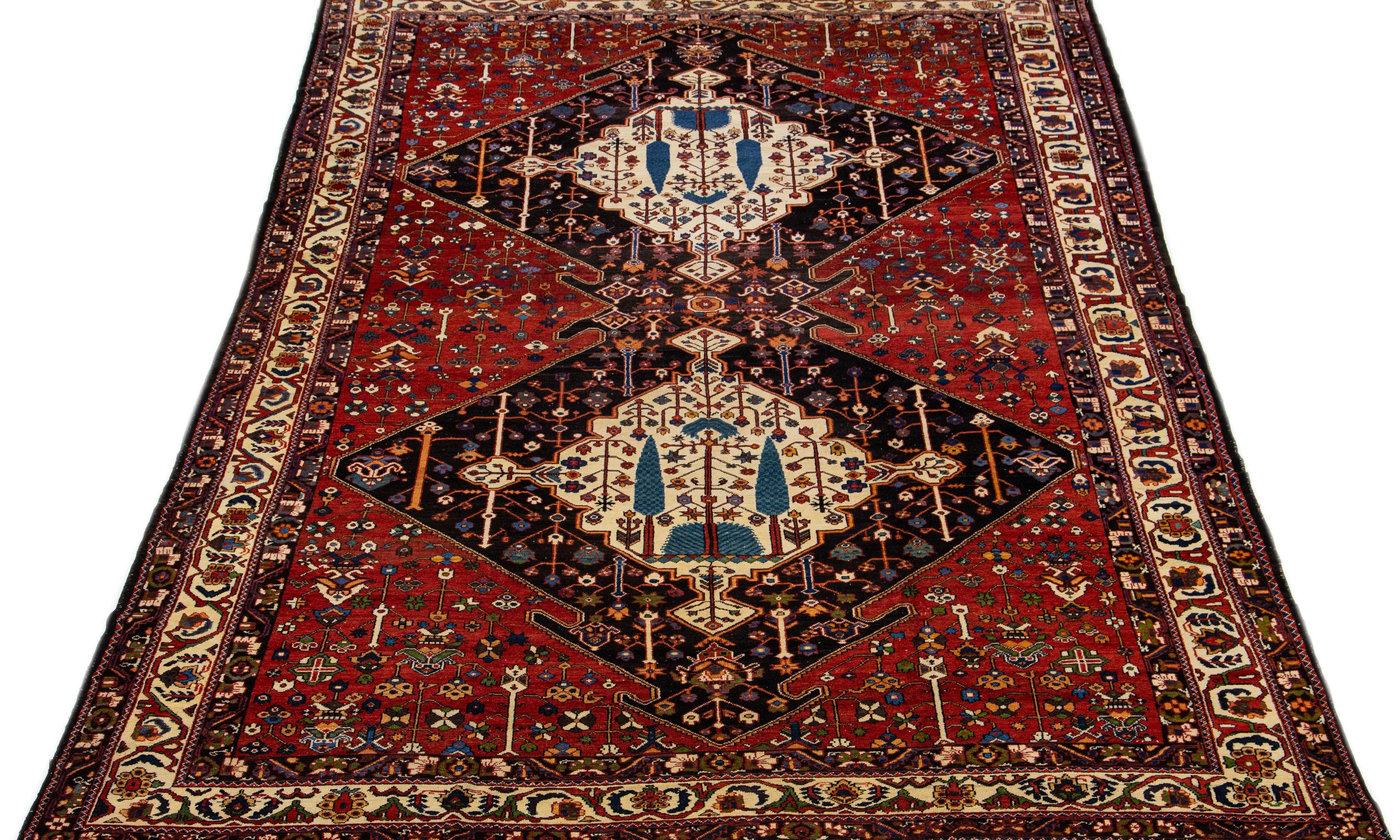 Crafted with precision and meticulous detail, this Bakhtiari hand knotted wool rug showcases a Classic tribal design set against a rust-colored field, highlighted by vibrant and colorful accents.

This rug measures 11'3