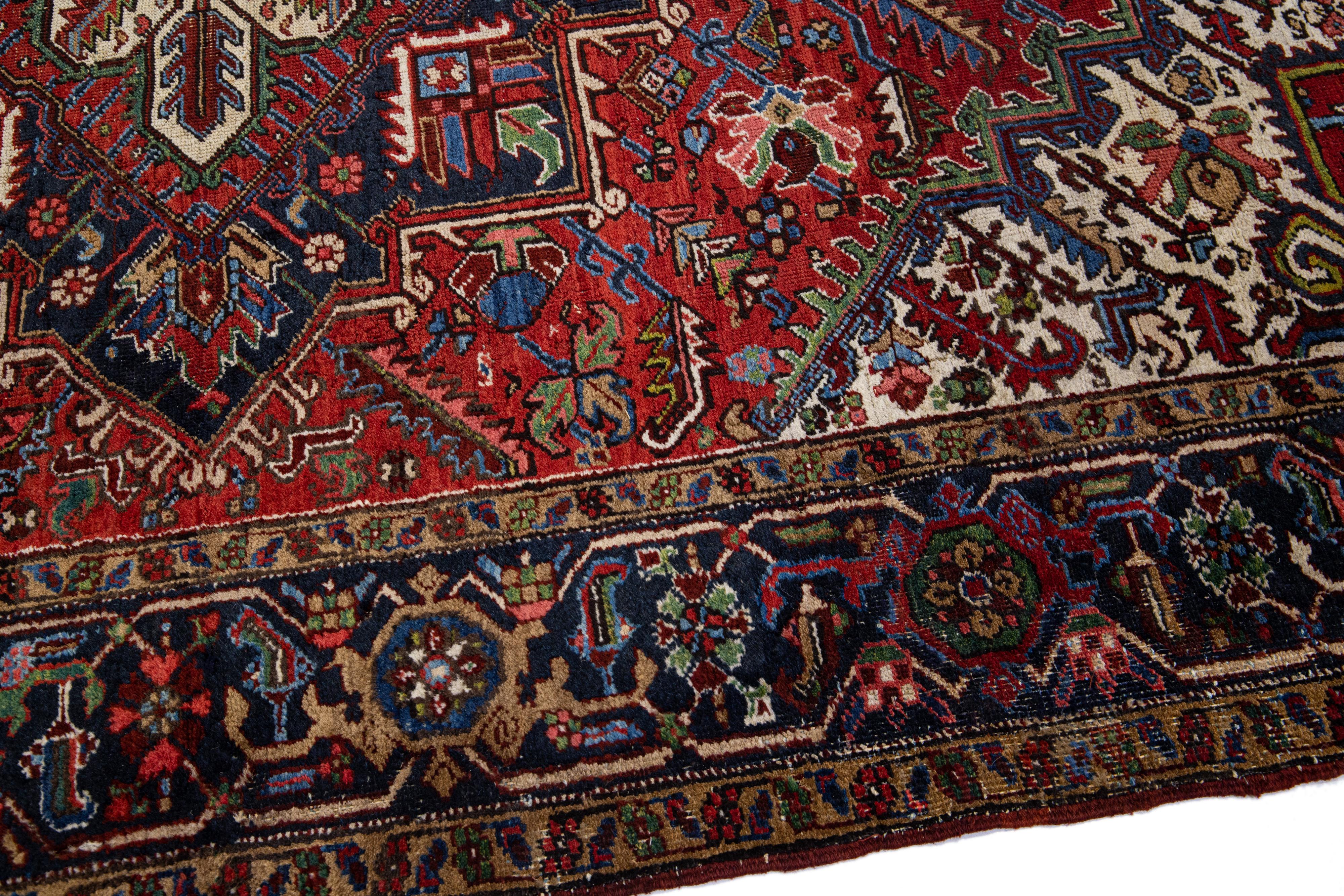 20th Century Red Antique Persian Heriz Handmade Wool Rug with Medallion Motif For Sale
