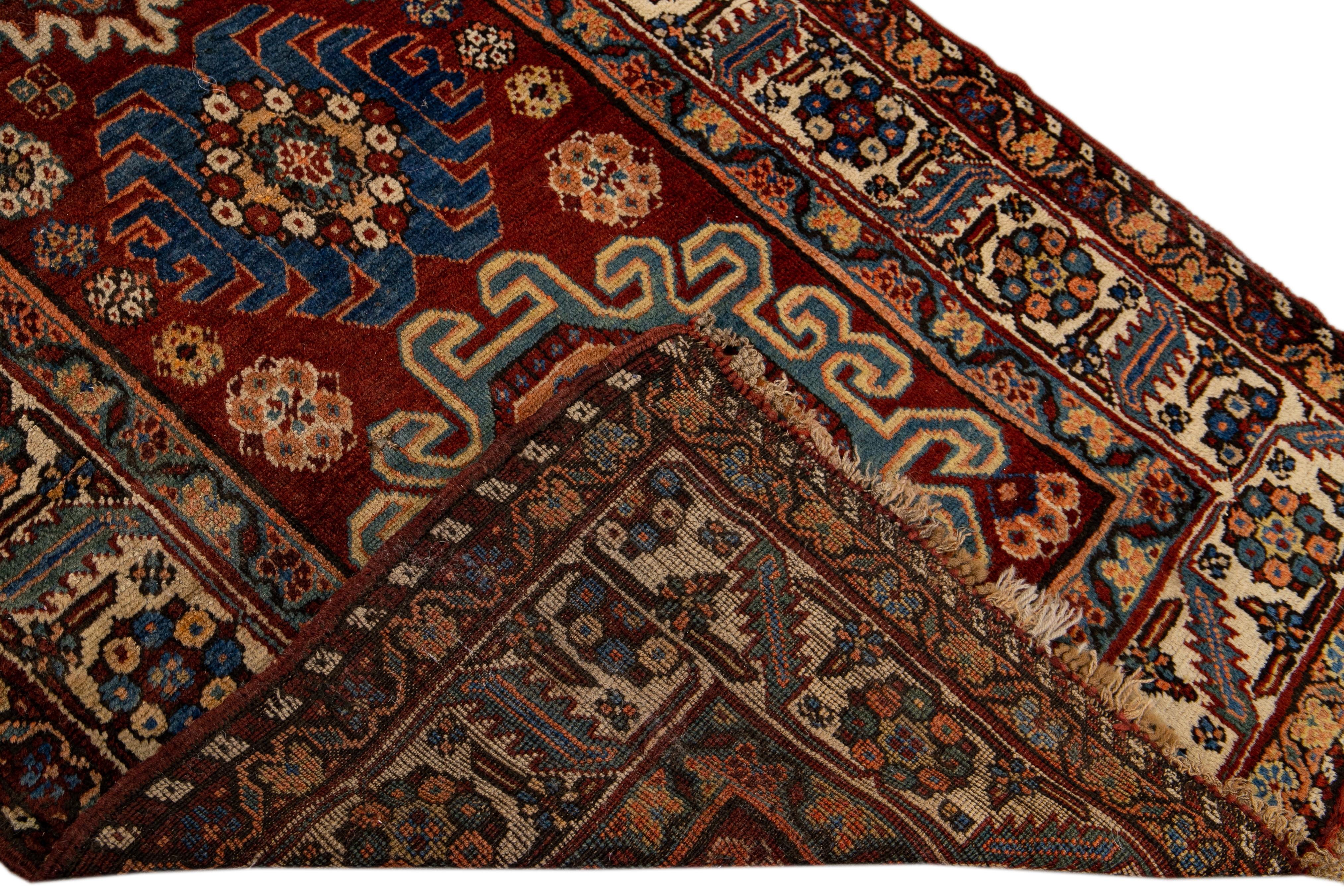 Beautiful antique Serapi hand-knotted wool rug with a red field. This Persian rug has a beige frame and multicolor accents in a gorgeous all-over geometric multi medallion floral motif.

This rug measures: 3'4