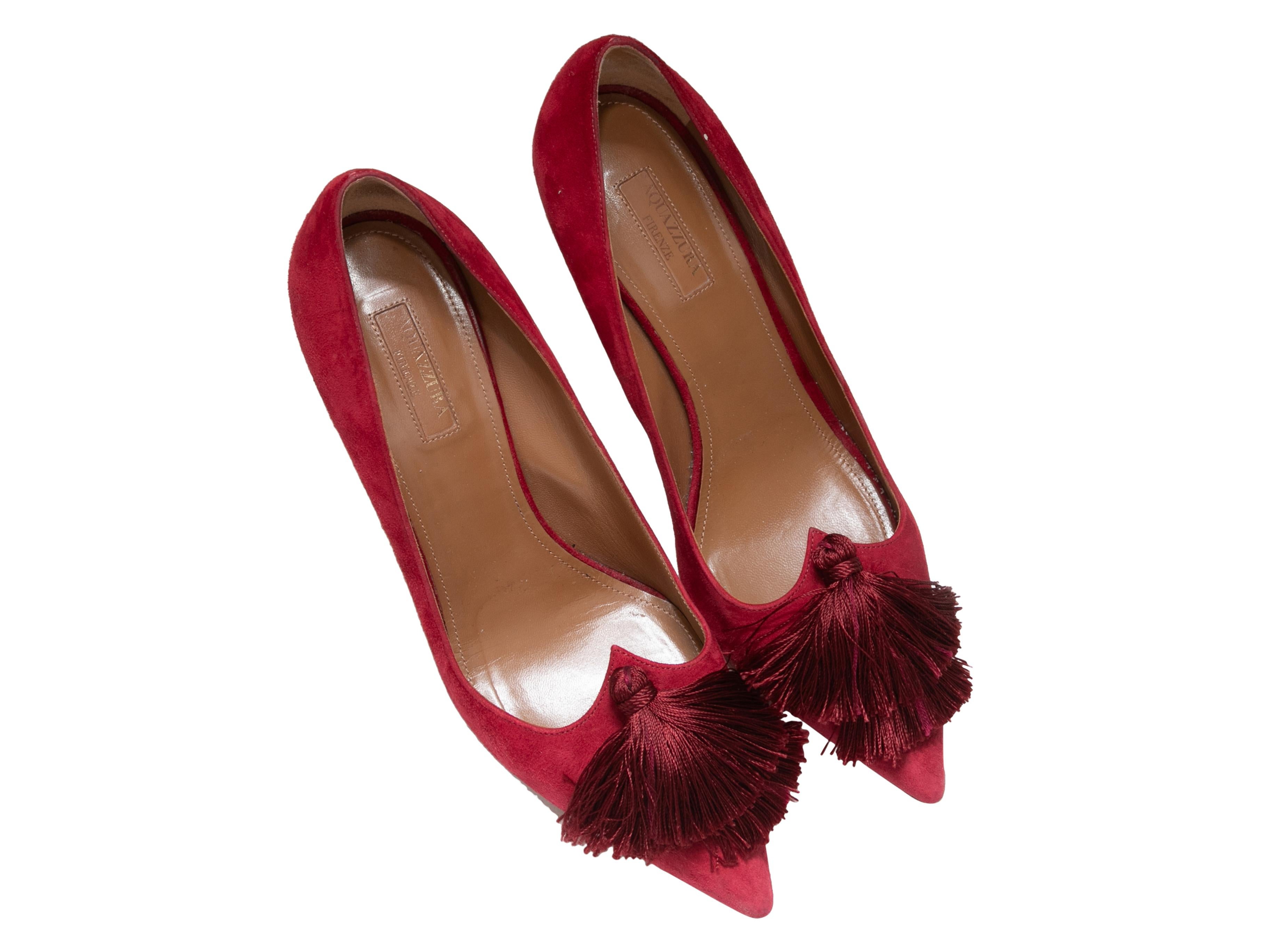 Product Details: Red suede pointed-toe pumps by Aquazzura. Tassel accents at tops. 3.75