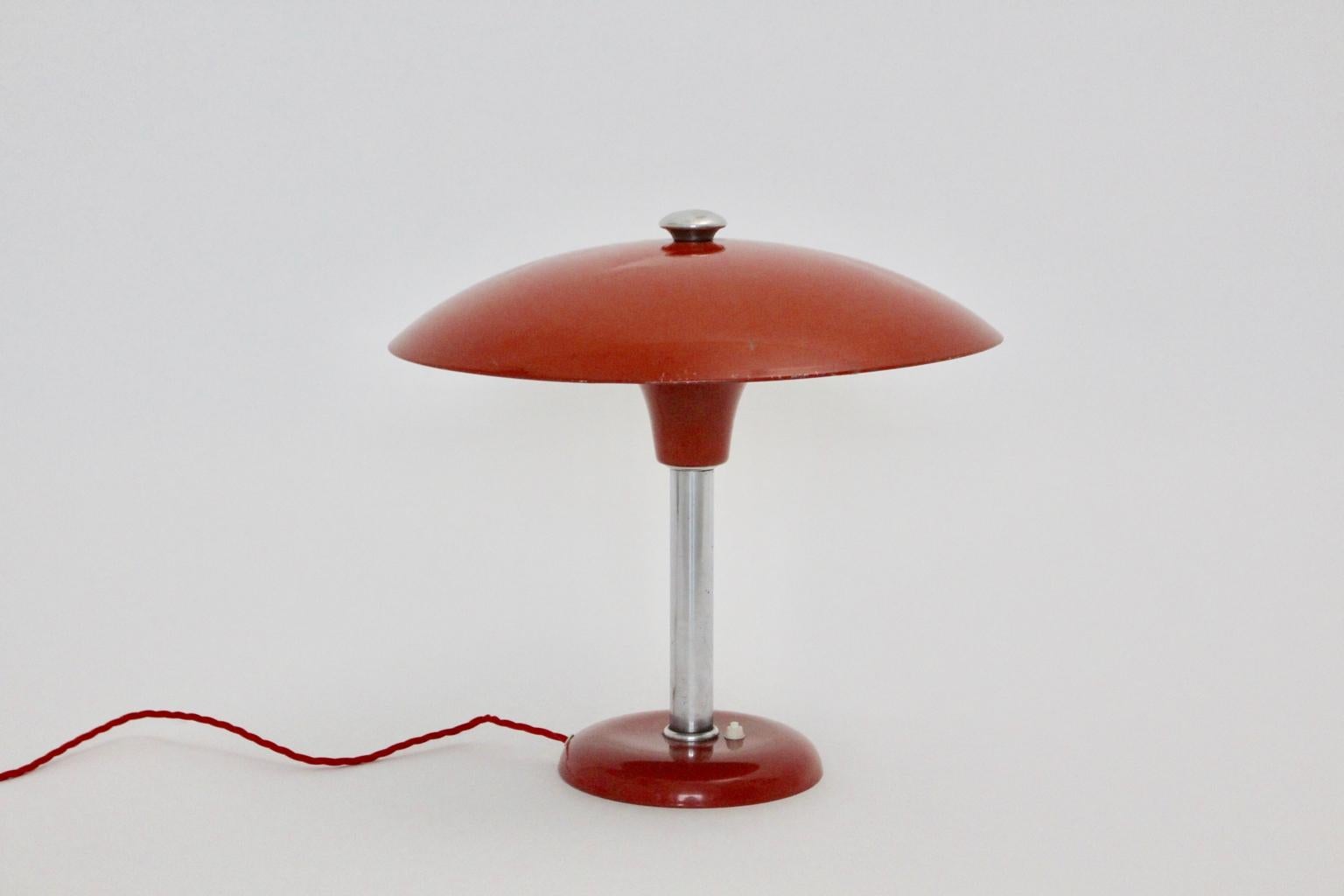 This presented rare red vintage desk lamp or table lamp designed by Max Schumacher 1934, executed by Werner Schröder, Lobenstein, Germany. Also the Bauhaus Era desk lamp is marked underneath MSW. Furthermore the desk lamp is in original condition