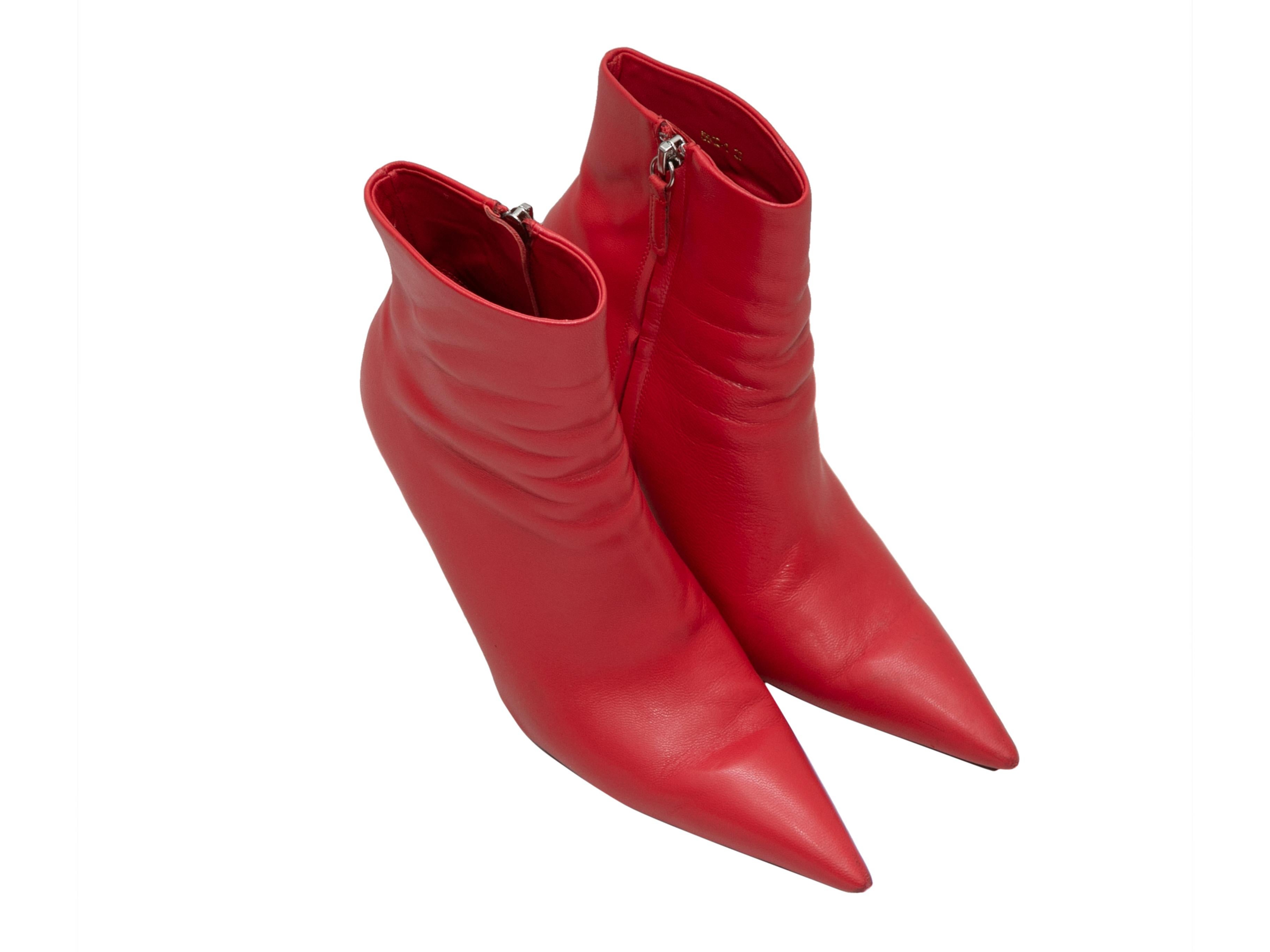 Red leather pointed-toe Knife ankle boots by Balenciaga. Spike heels. Zip closures at inner sides. 4.75