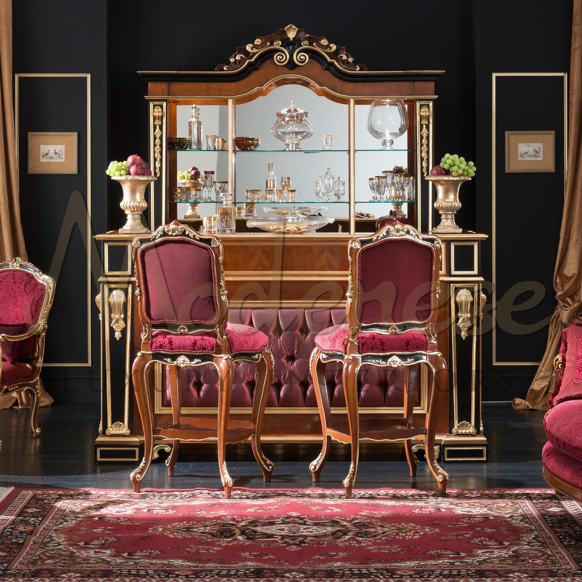 Luxury baroque-style bar stool in natural bright walnut finish and black touches with gold leaf applications. This seating element, which completes the Modenese Home Bar set, has a damascus red fabric with classic floreal patterns. Every piece of