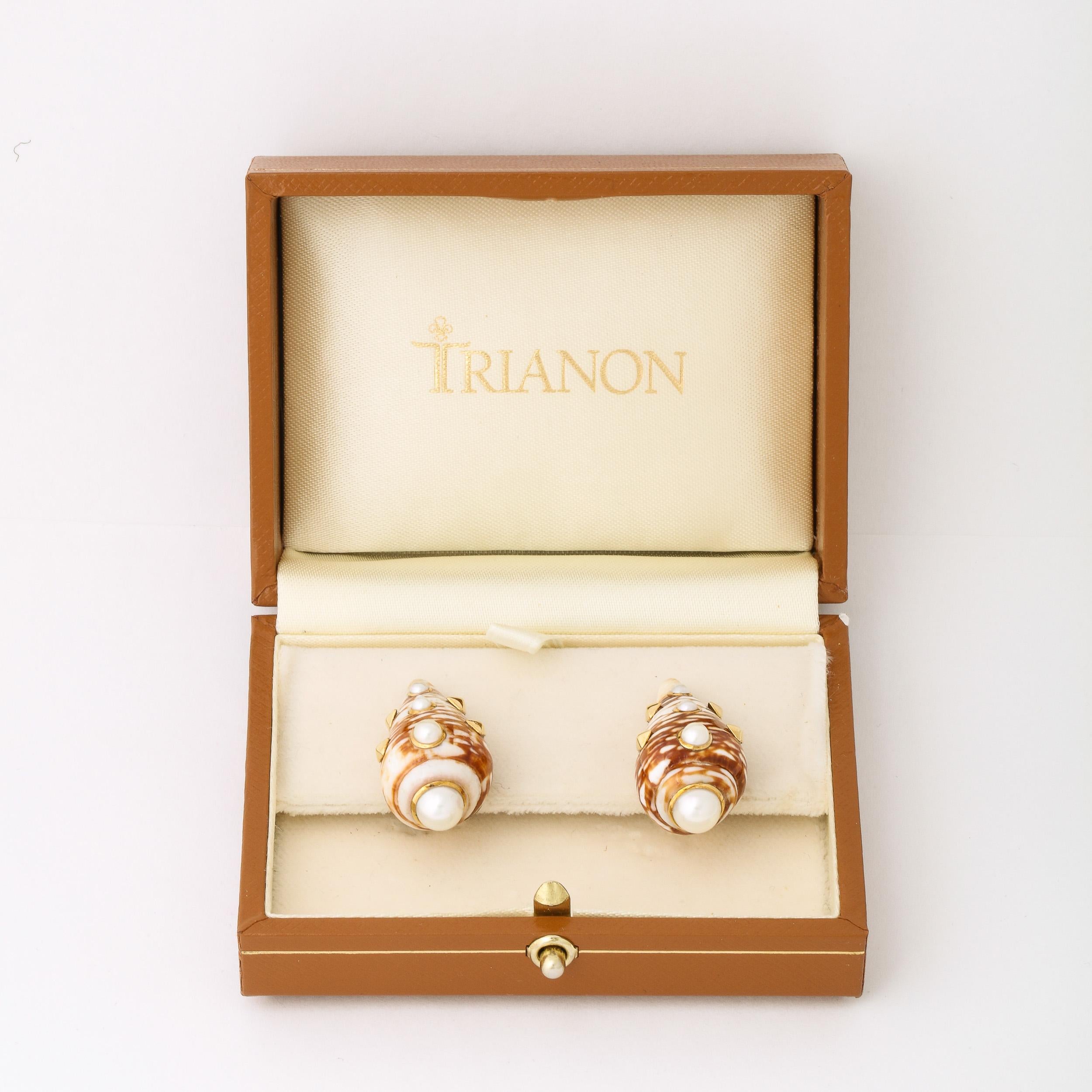 These beautiful earrings in Iron Red & Beige Shells, set in 18k Gold With Inlaid Pearls by Trianon. They feature an elegant blend of Metal and Organic materials, gorgeously set in 18k Gold that circumscribes the inlaid graduated pearl motif that