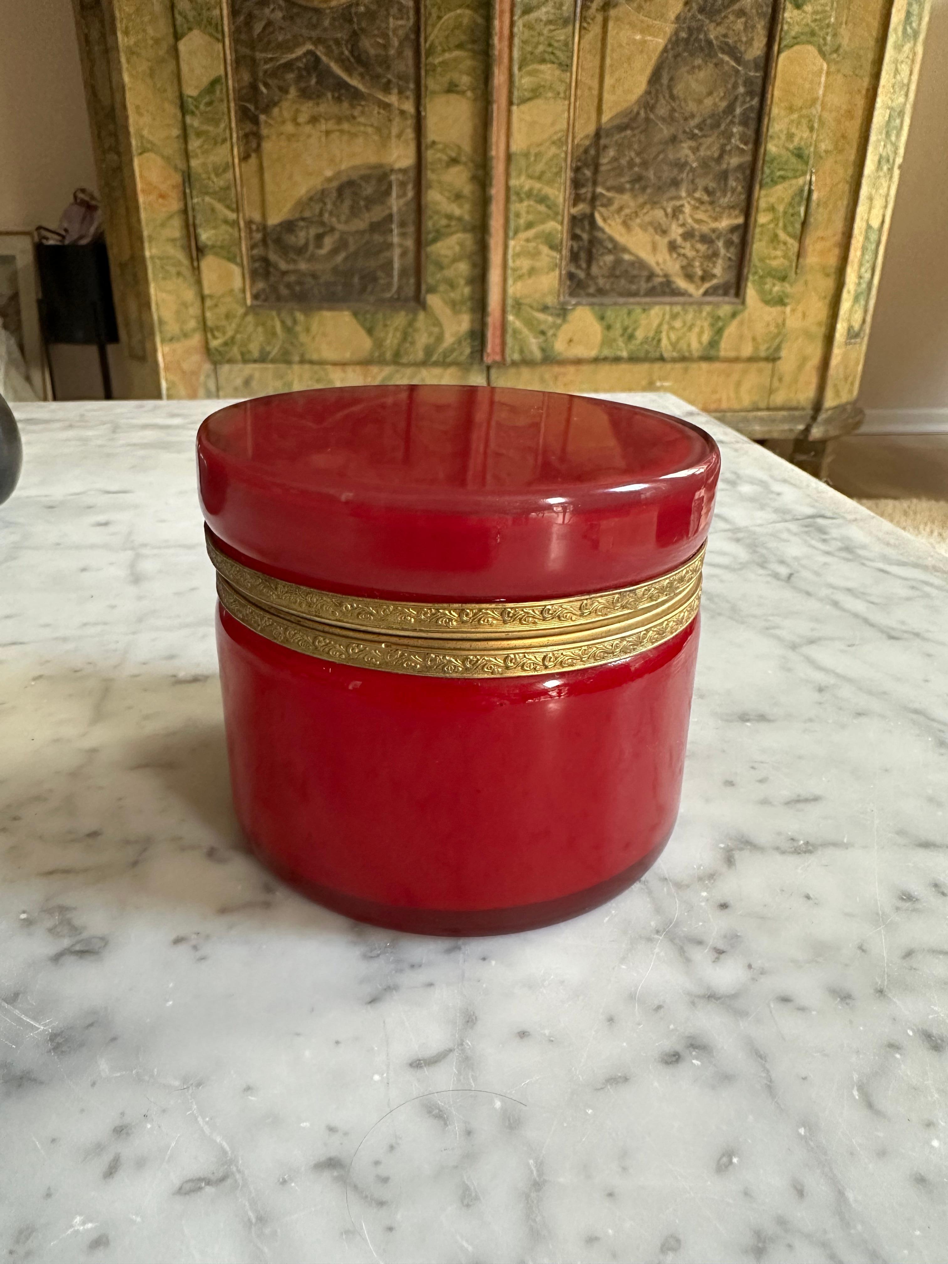 Sumérgete en la elegancia de la época Biedermeier con esta exquisita caja con tapa de cristal superpuesto. Esta pieza destaca por su maestría artesanal y la armoniosa combinación de materiales.

La caja está fabricada con cristal de leche blanco en