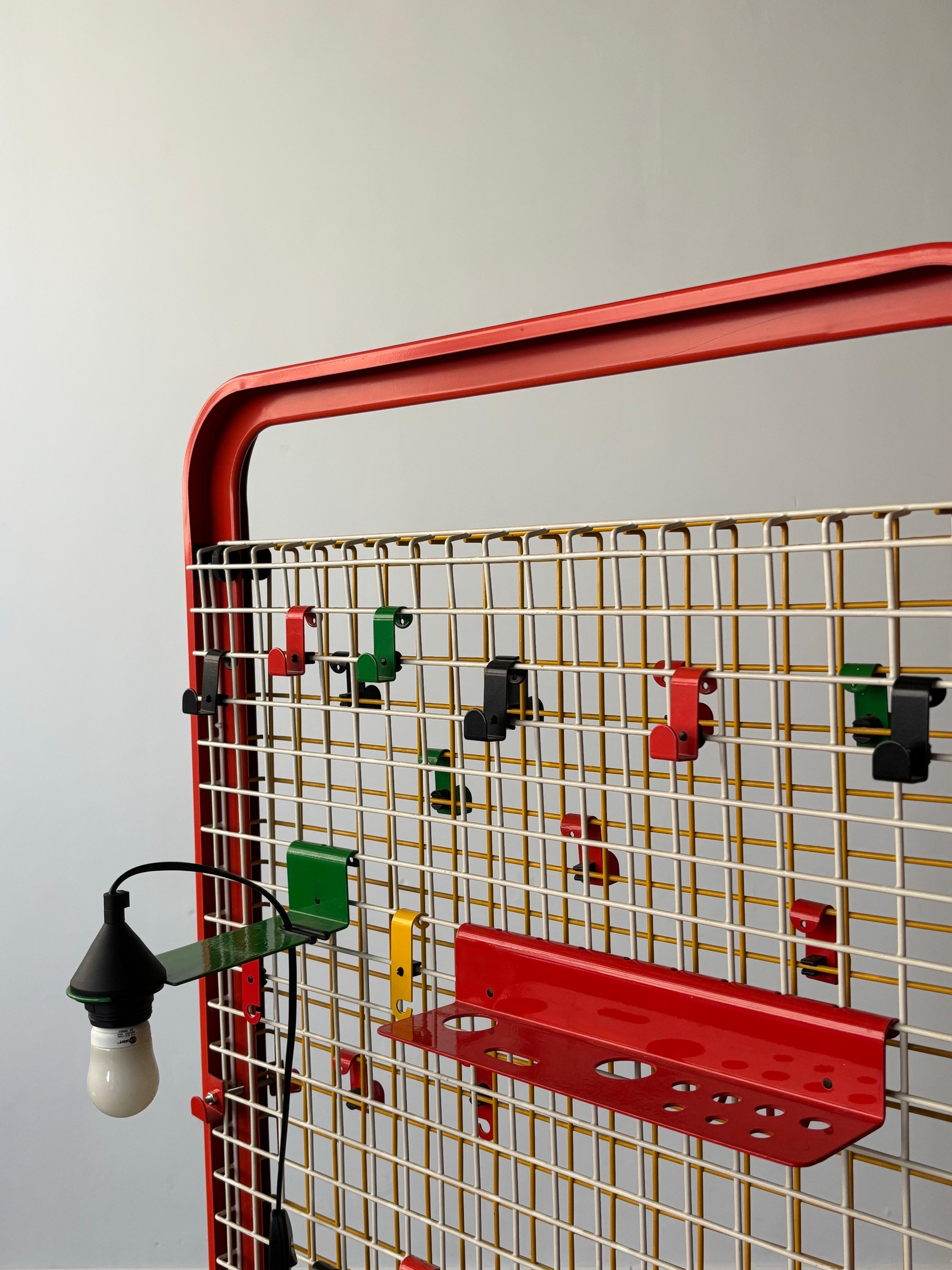 The Red Binetta Organizer, designed by Boccato, Gigante & Zambusi for Seccose in the 1980s, is a striking example of postmodern Italian design. Crafted from vibrant red metal, its modular and geometric form offers both visual impact and practical