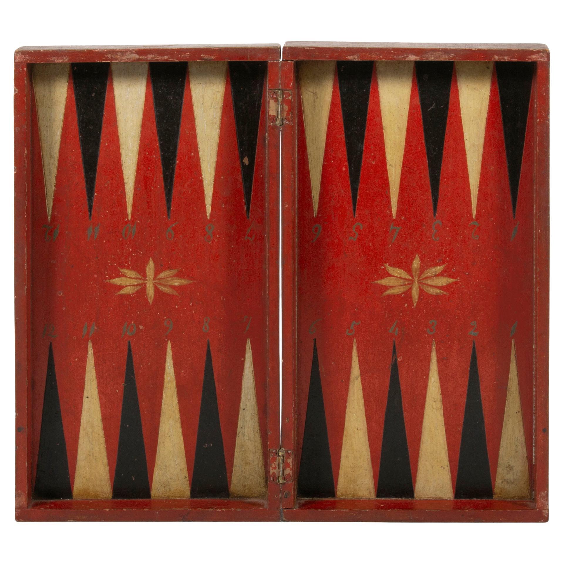 Plateau de jeu de backgammon pliant peint en rouge, noir et ocre blanc, vers 1870-1890