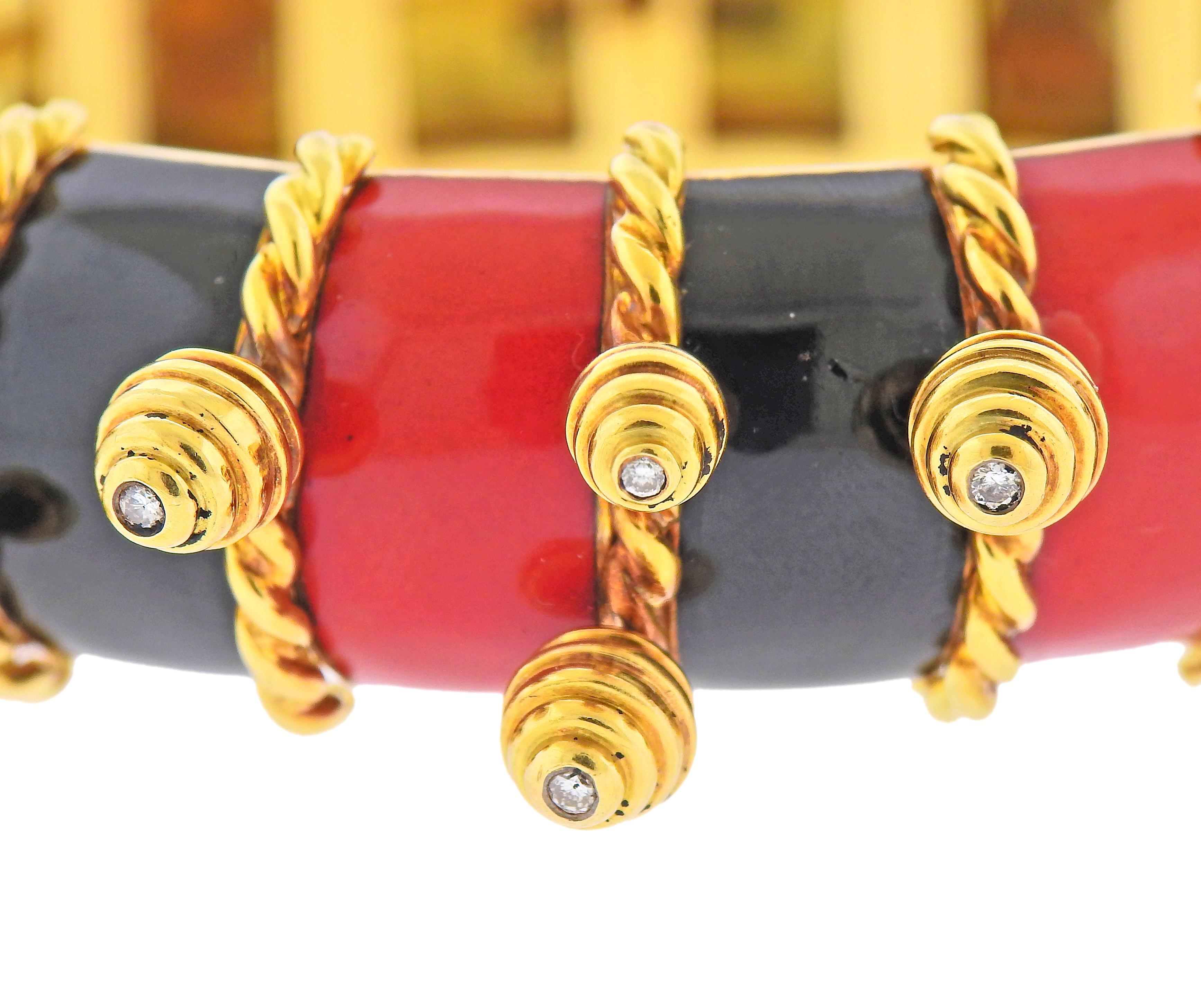18k gold bangle bracelet with charms, each set with a diamond in the center. Bracelet decorated with black and red enamel. Will fit approx. 7.5