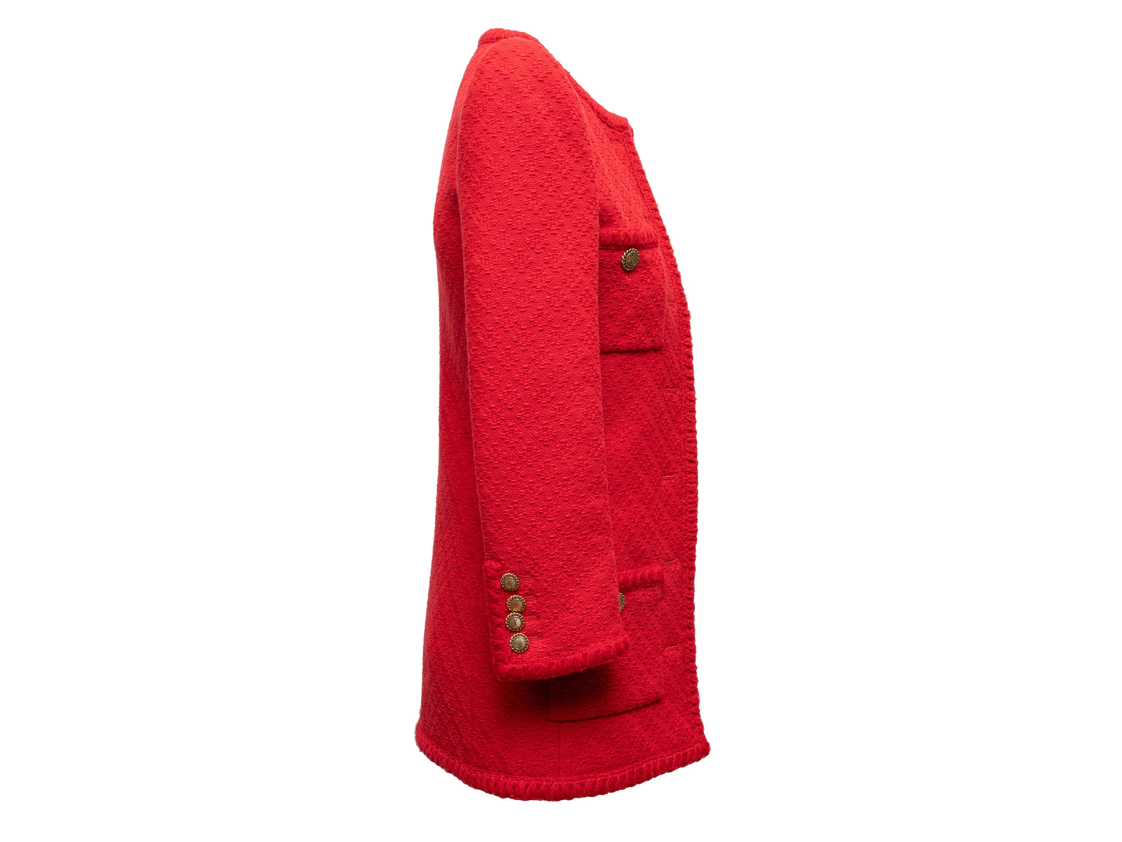 Red and black longline wool tweed jacket by Saint Laurent. Circa 2021. Crew neck. Structured shoulders. Four front pockets. Gold-tone button closures at center front. 30