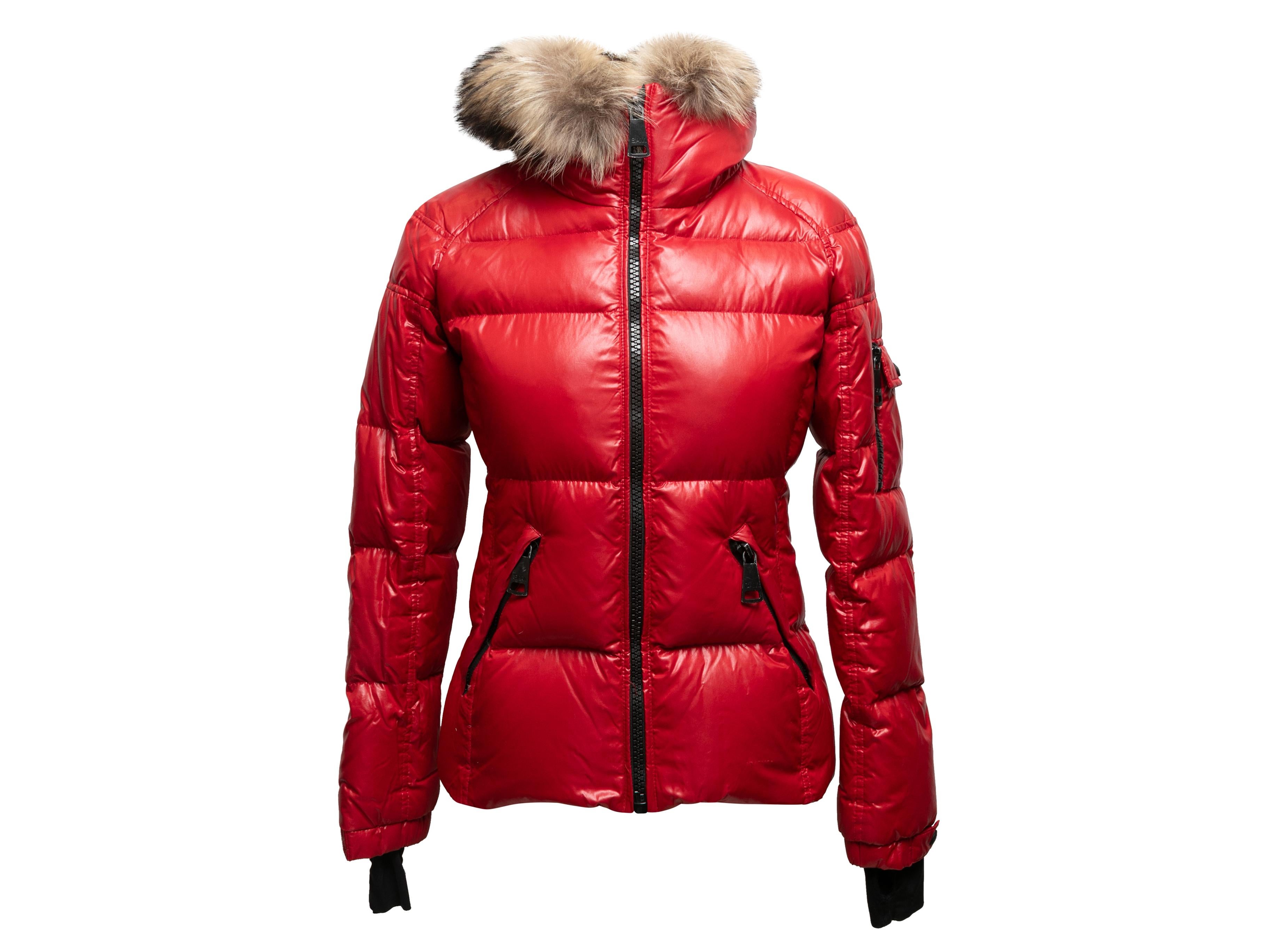 Red and black hooded fur-trimmed down puffer jacket by Sam. Dual hip pockets. Sleeve pocket. Zip closure at front. 32