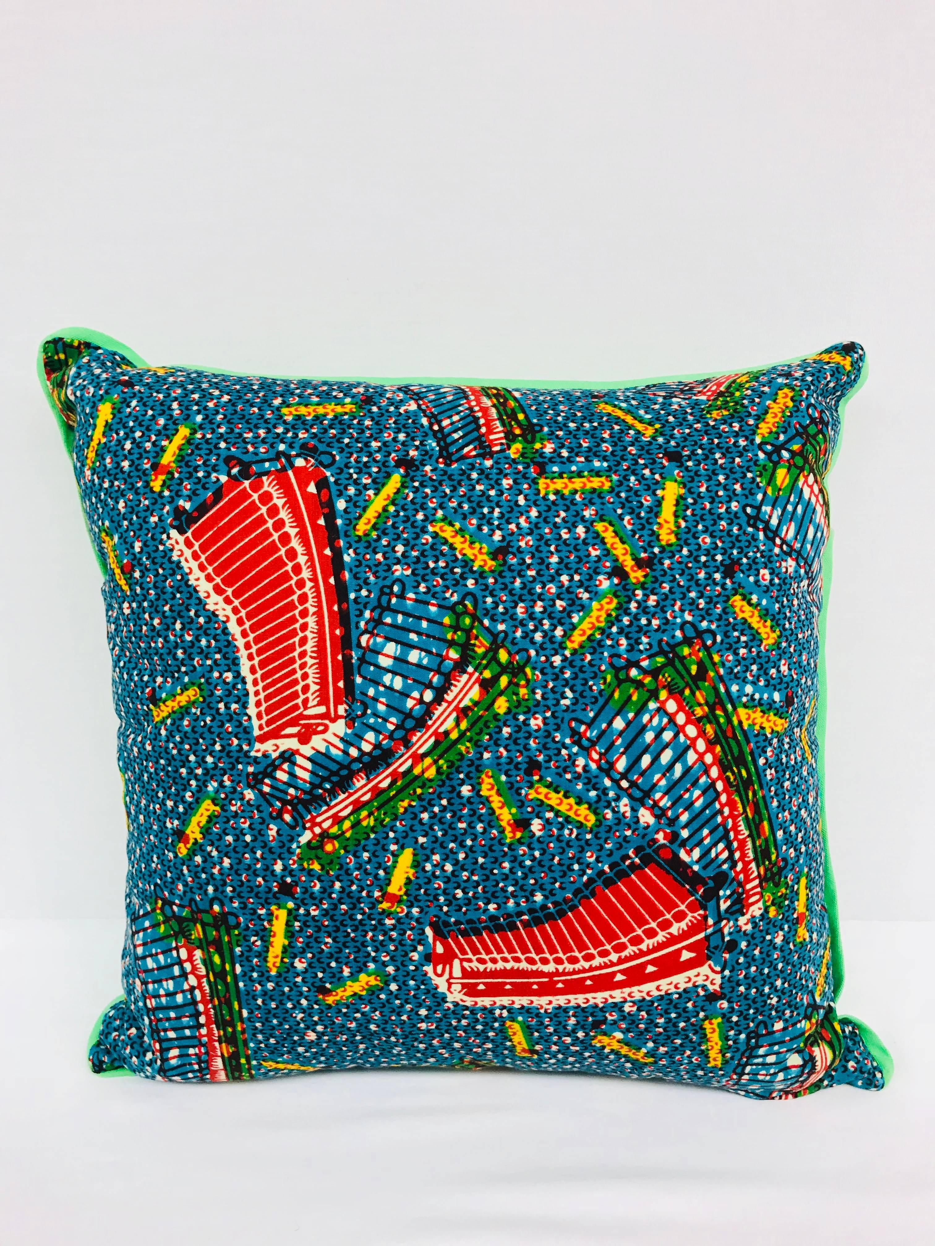 Crafted in the USA exclusively for Madcap Cottage, this African wax print pillow will bring a big dollop of delicious to a neutral sofa, bed or chair. Back in a kicky green cotton. Made from Vlisco authentic Dutch wax fabrics. Hidden zipper. Down