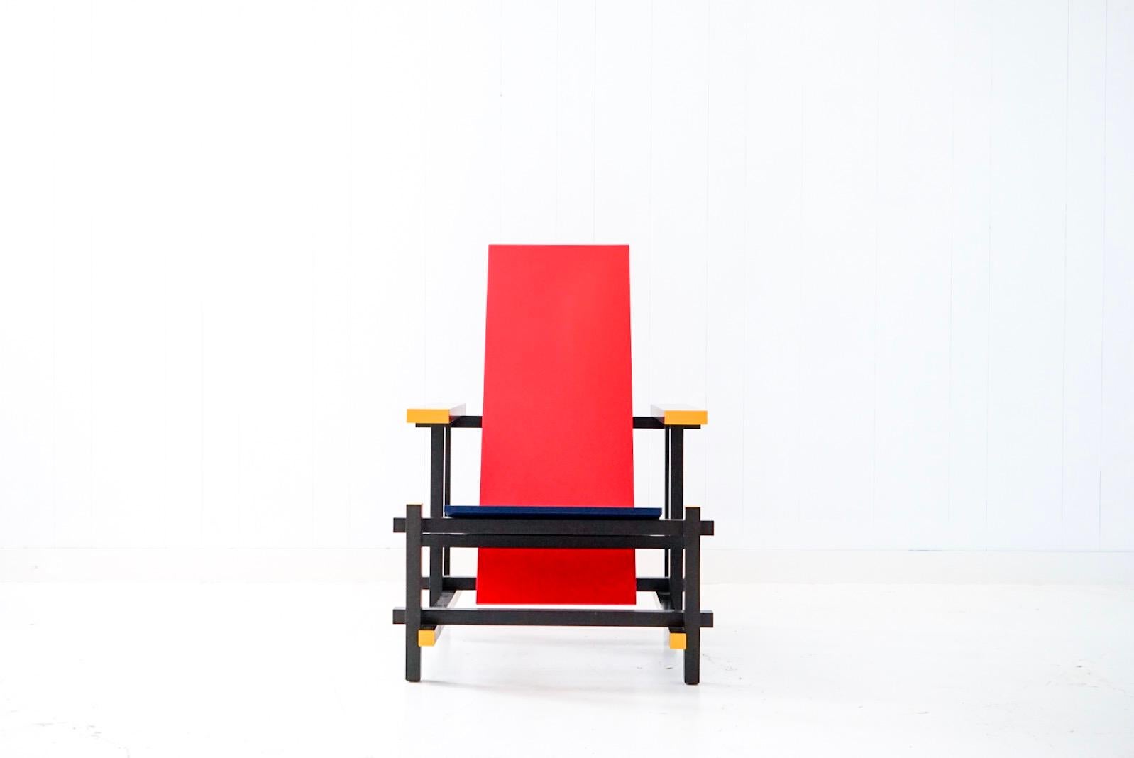 An incredibly clean example of an authentic signed Cassina red blue armchair by Gerrit Rietveld. This piece was owned by a single owner who kept it as an un-used sculpture rather than a chair to use therefore it a very clean vintage example.