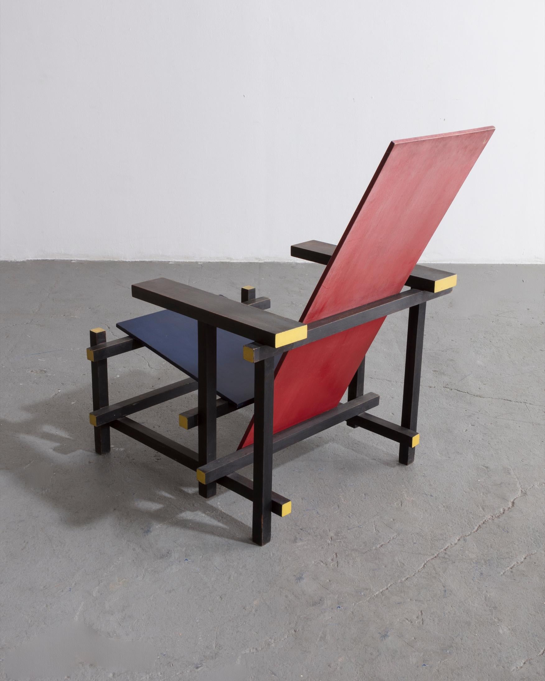 Red blue chair. Designed by Gerrit Rietveld, 1919. This example made circa 1950 by Gerard van de Groenekan. Cabinetmakers paper label on rail beneath the seat.