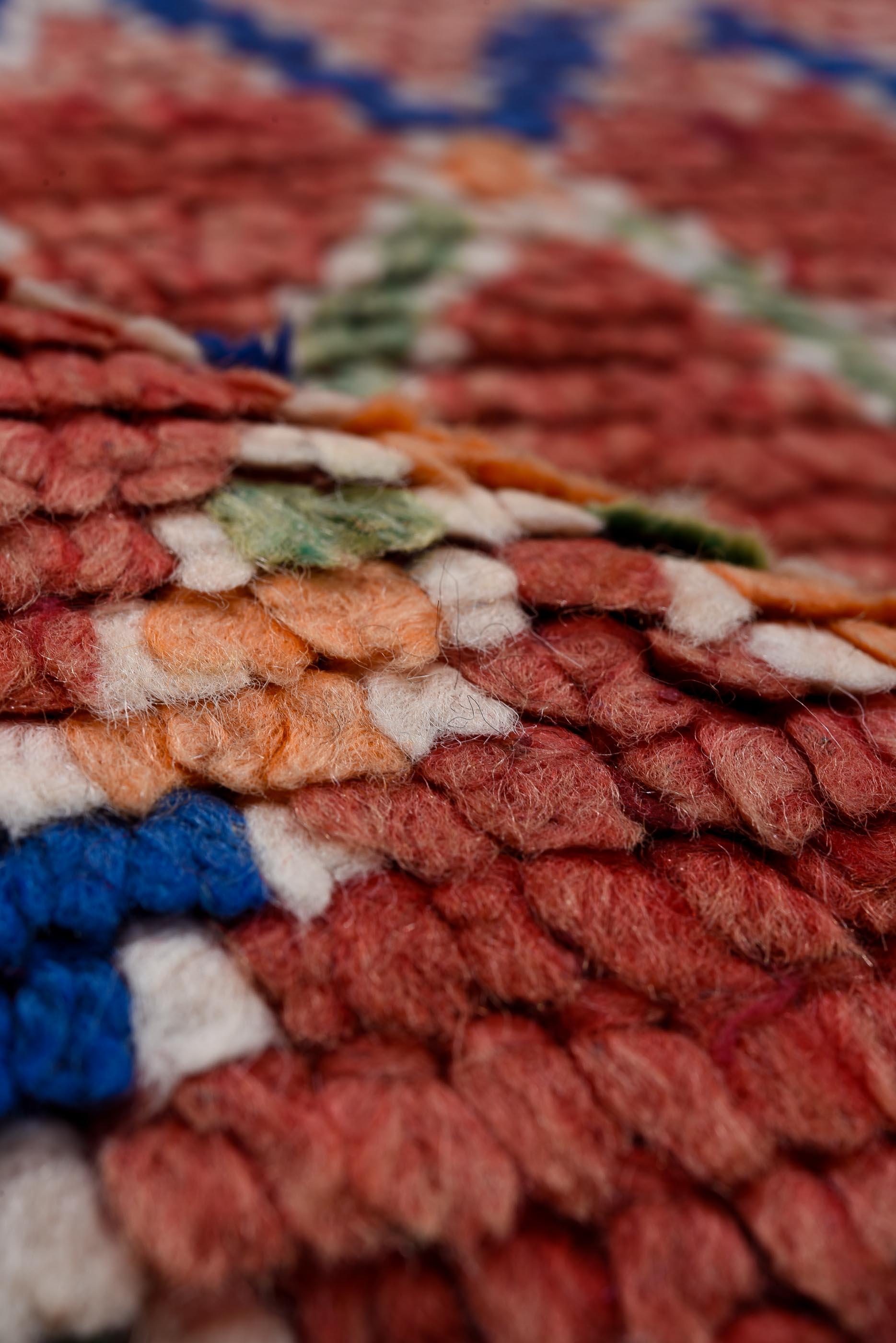 Beautiful, like-new, handmade Moroccan rug with light blue diamond pattern stitching throughout.