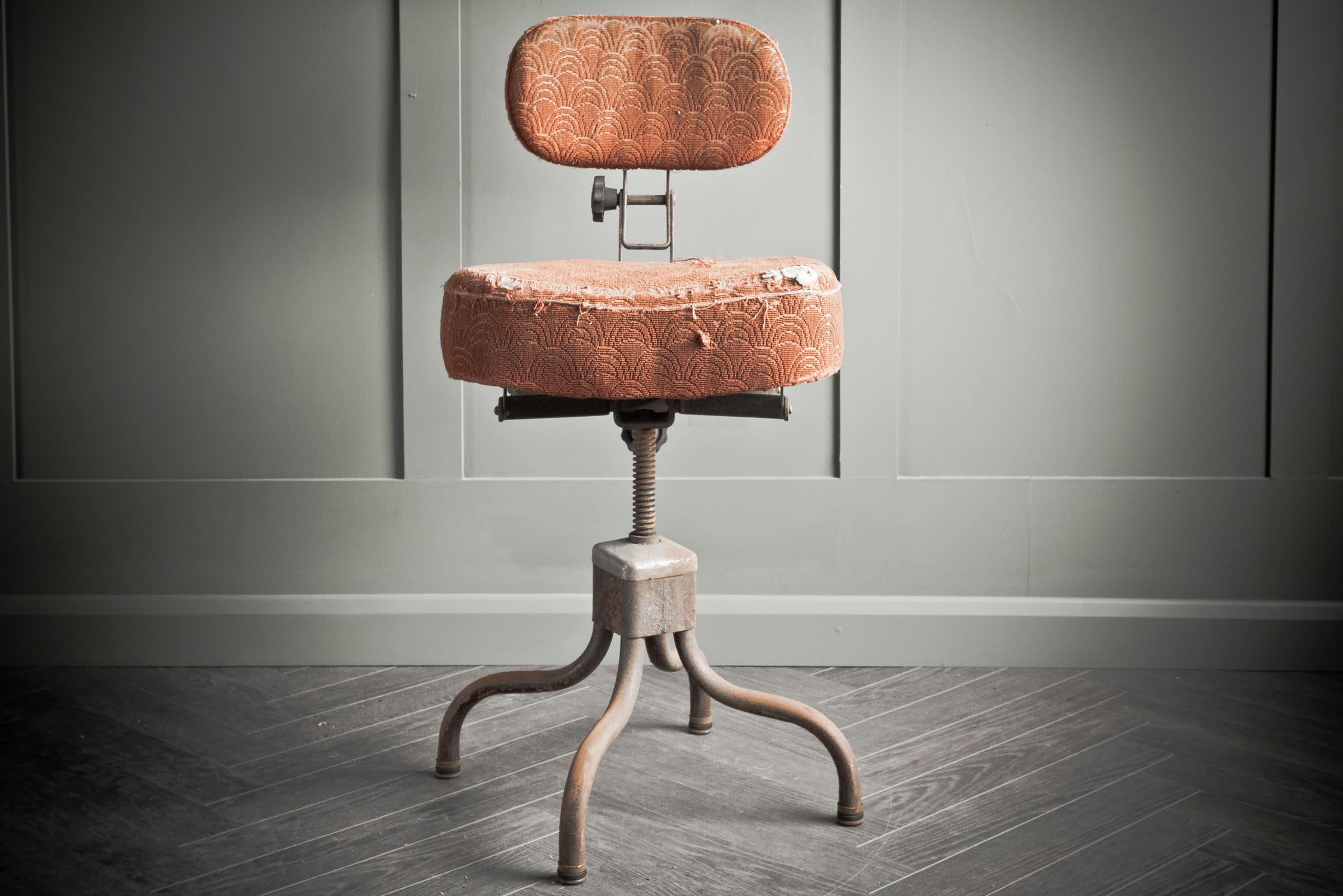A functional and practical industrial “Evertaut”  stool circa 1940s. Covered in a red boucle with fading to authentically show age and use. A very comfortable and ergonomic chair. Adjustable back, seat and height mechanism. Original Evertaut factory