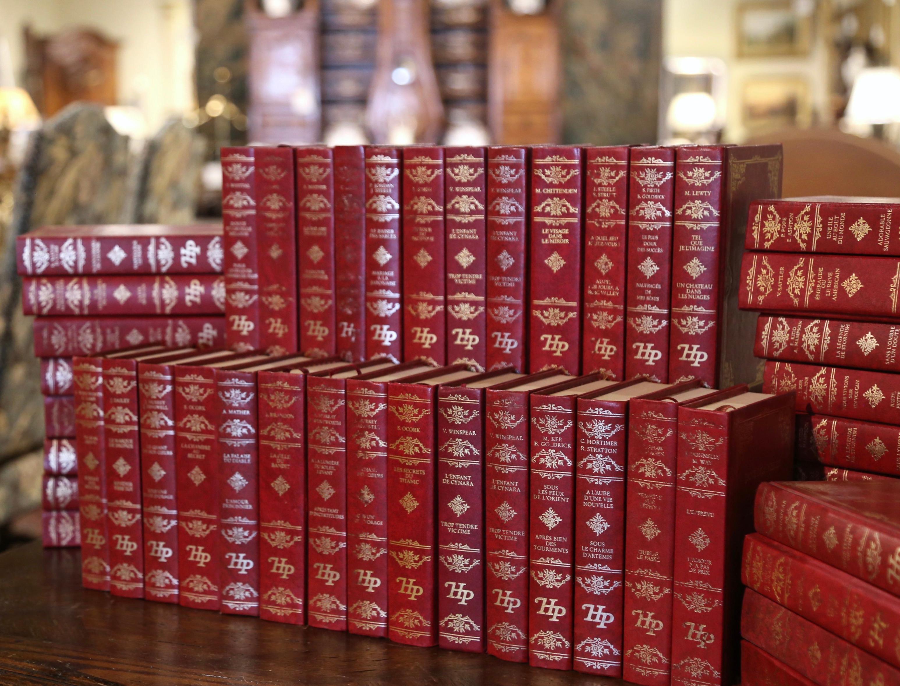 Decorate a study or a library with this elegant set of French books, printed in Paris between 1989-1989, each book has a red bound cover embellished with gilt motifs. The set of 48 books titled 