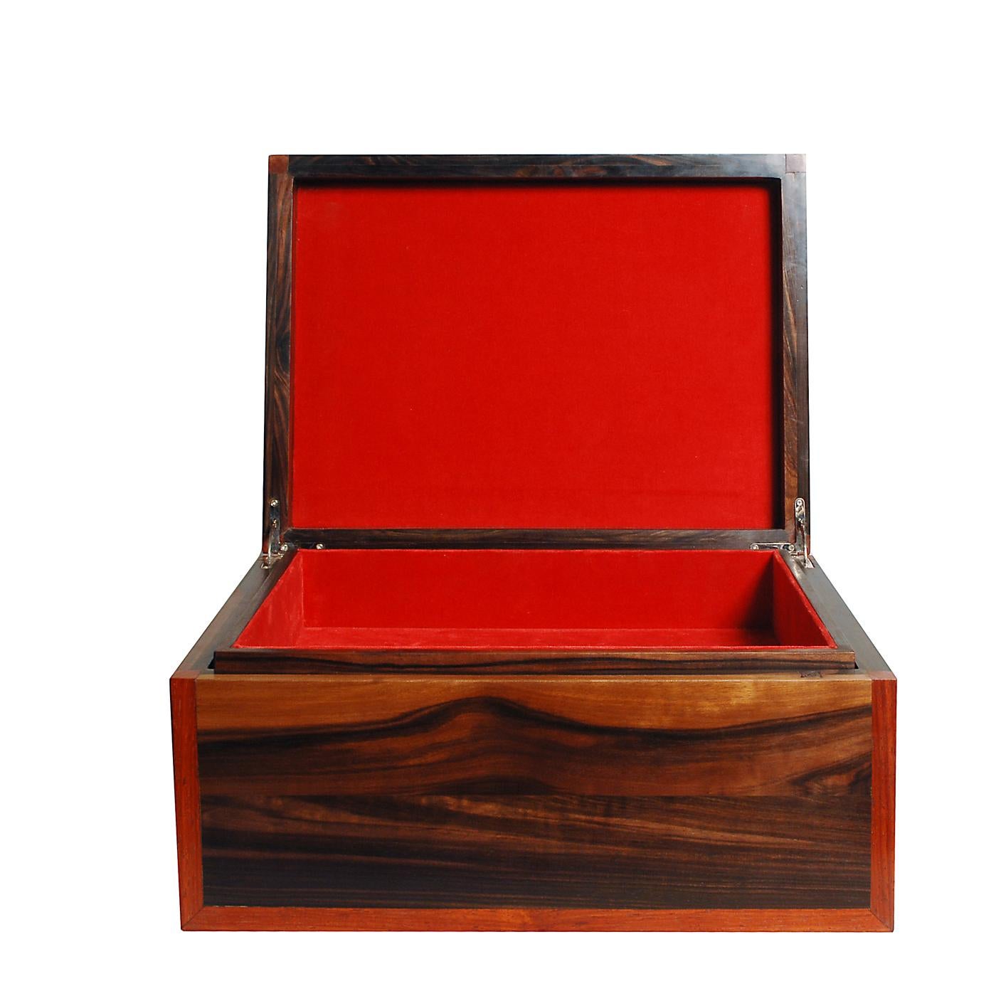 This exquisite box in solid makassar ebony wood is lined on the inside with red velvet. It features one tray also lined with red velvet. This box is customizable with the option of different materials, dimensions and inside layout.