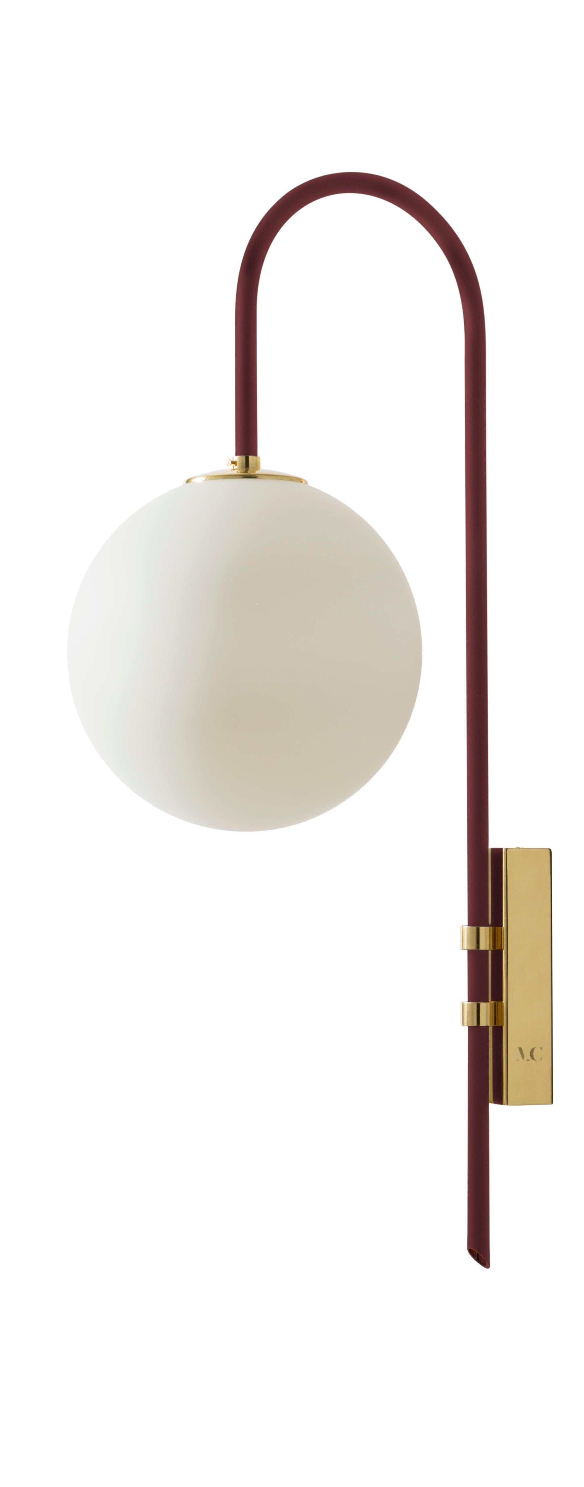 Red brass wall lamp 06 by Magic Circus Editions
Dimensions: H 77 x W 25 x D 36.5 cm
Materials: Smooth brass, mouth blown glass
Sphere dimensions: 25 cm

Available finishes: Brass, nickel
All our lamps can be wired according to each country. If