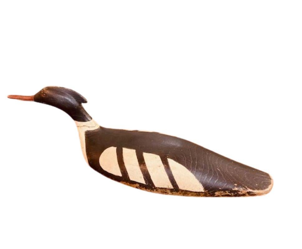 Vintage Red Breasted Merganser Drake Decoy, circa 1960s - 1970s, a hand carved and hand painted red breasted merganser drake decoy in a swimming posture with slightly turned and canted head, with carved crest, bill mandible and nares, glass eyes,
