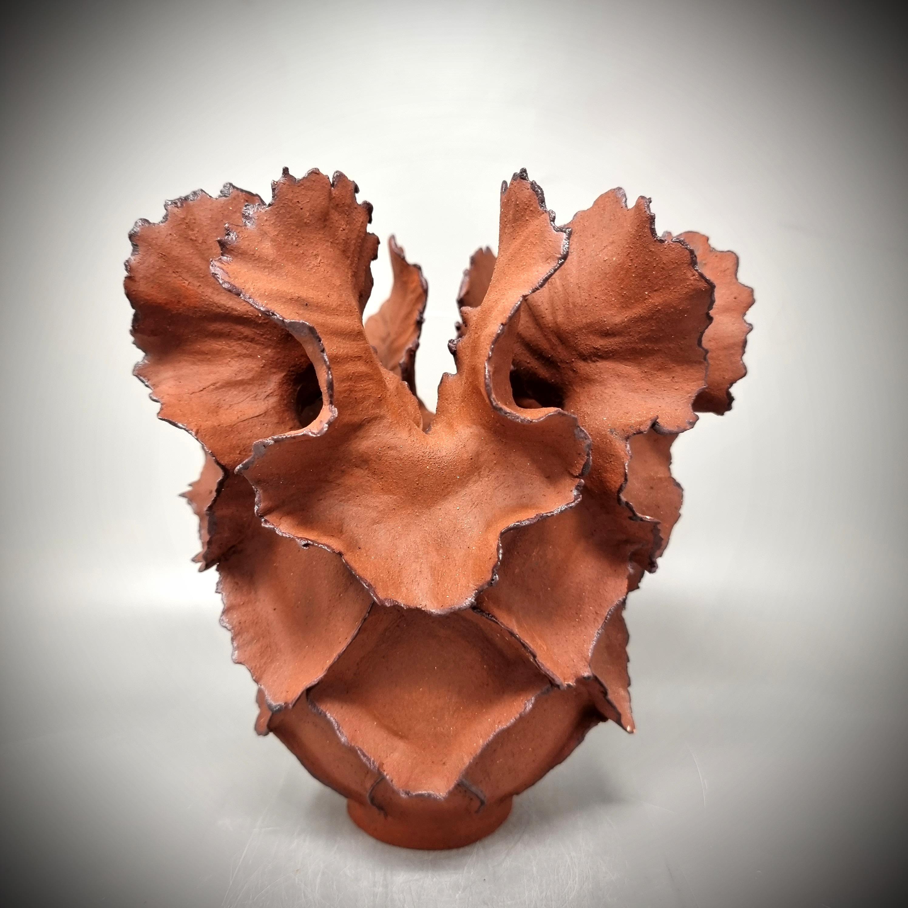 Handbuilt Stonewear Sculpture in red/braun stonewear clay

It is sculpted by hand, slowly adding coils and clay to create the final result. This is a piece of art based on classic sculpting methods. 
 
The color of the sculpture hcanges