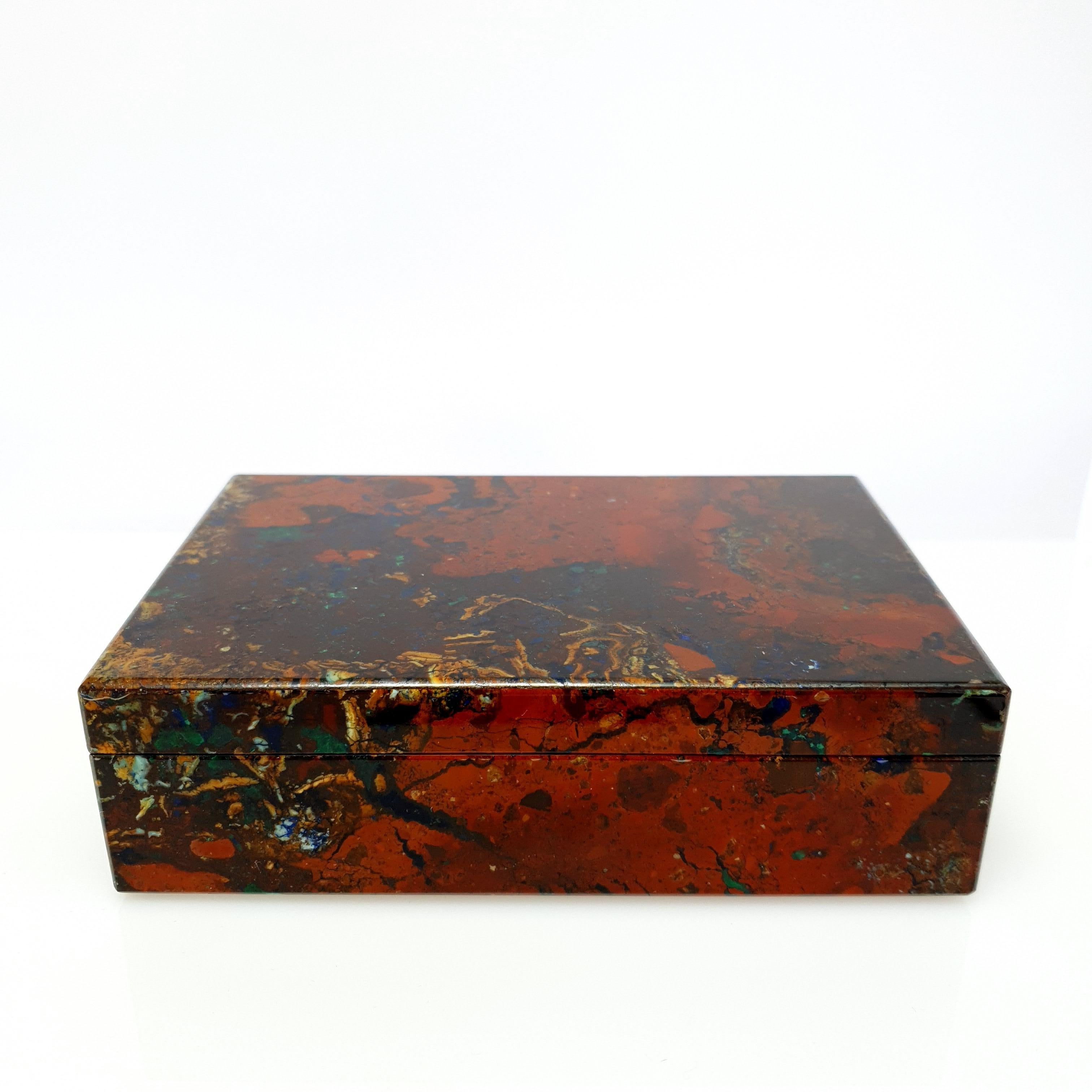 A Natural Handmade Red Brown Zarinite  and Black Marble Decorative Jewelry Box.
The colourful combination of blue Azurite, green Malachite and the red brown pattern looks like an artful painting of nature.
It should be emphasized that the top plate