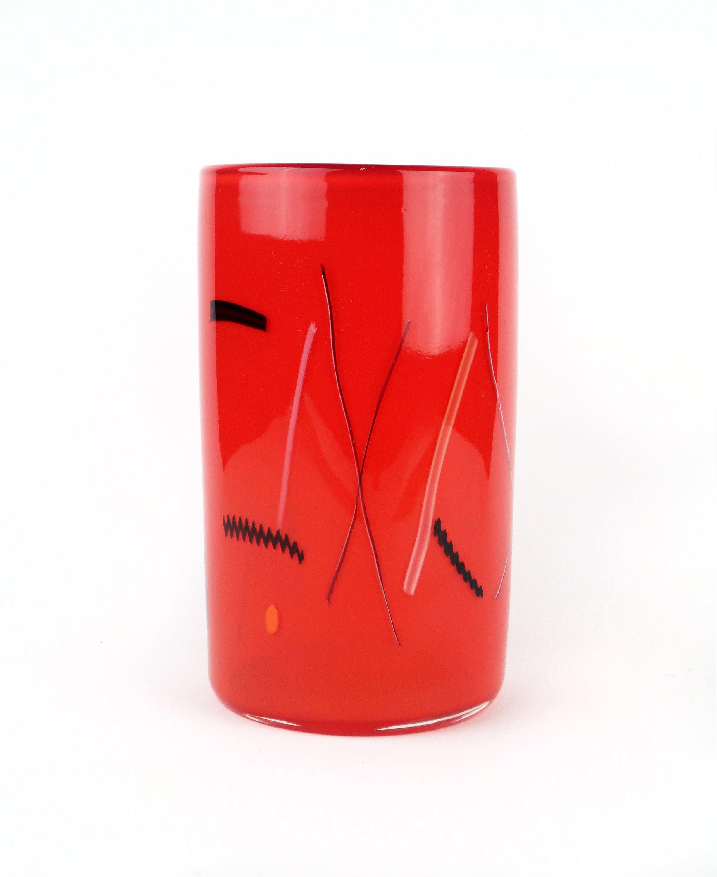 Bright and beautiful red cylindrical art glass vase by husband and wife team, Bruce Pizzichillo and Dari Gordon, with black, white, yellow and orange fused accents. The Pizzichillo Gordon studio has been producing work since 1984 and can be found in