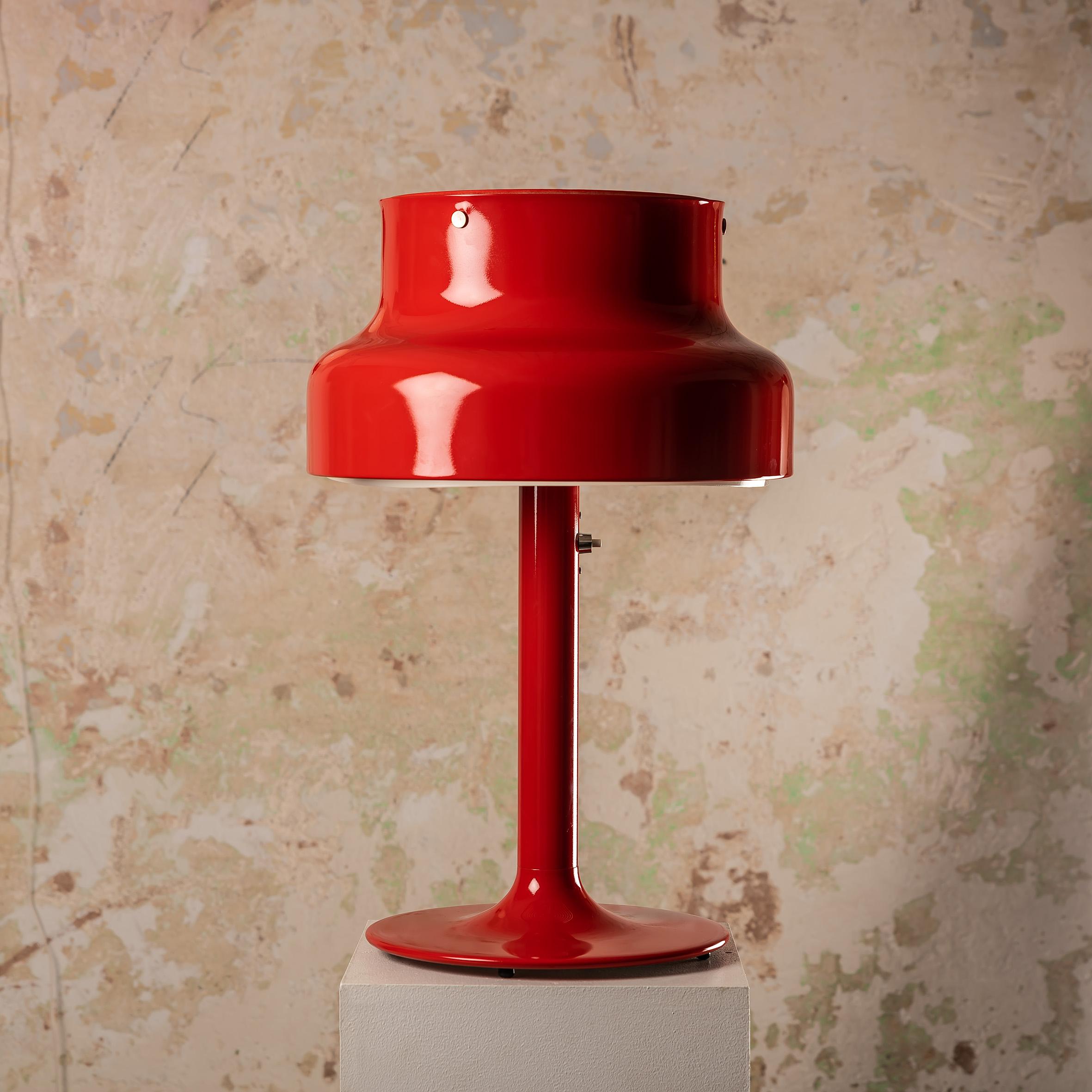 The custom RED Bumling table lamp, designed by Anders Pehrson for Ateljé Lyktan in the 1970s, is a remarkable piece that brings a bold and vibrant touch to any space. This lamp epitomizes Scandinavian design principles, blending functionality,