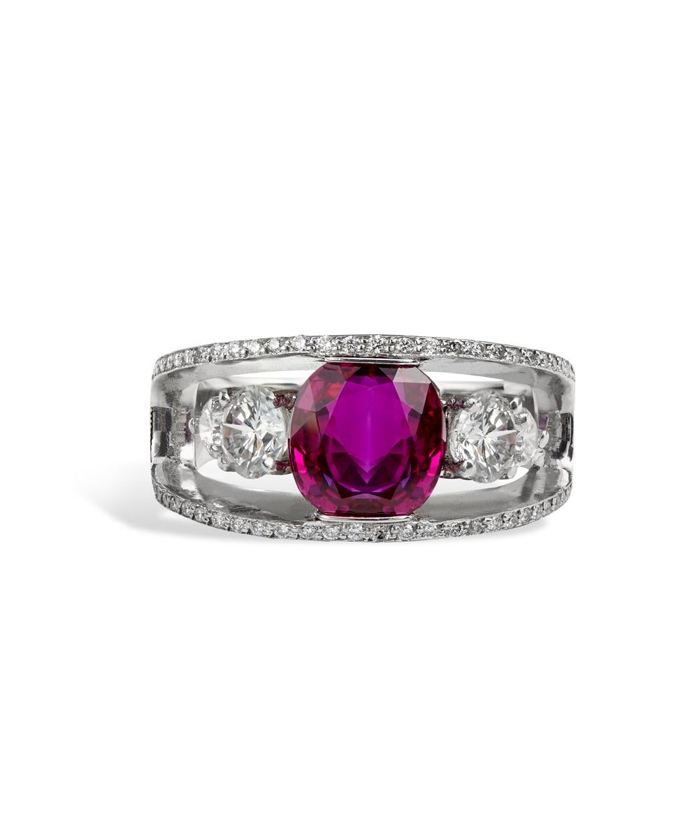 This oval Burma ruby platinum ring is enhanced by a custom made mounting that gives the illusion that the center stones are floating within the micro diamond pave set boarders. The Burma Ruby is 3.01 CTS and has te - heat enhancement only with GIA