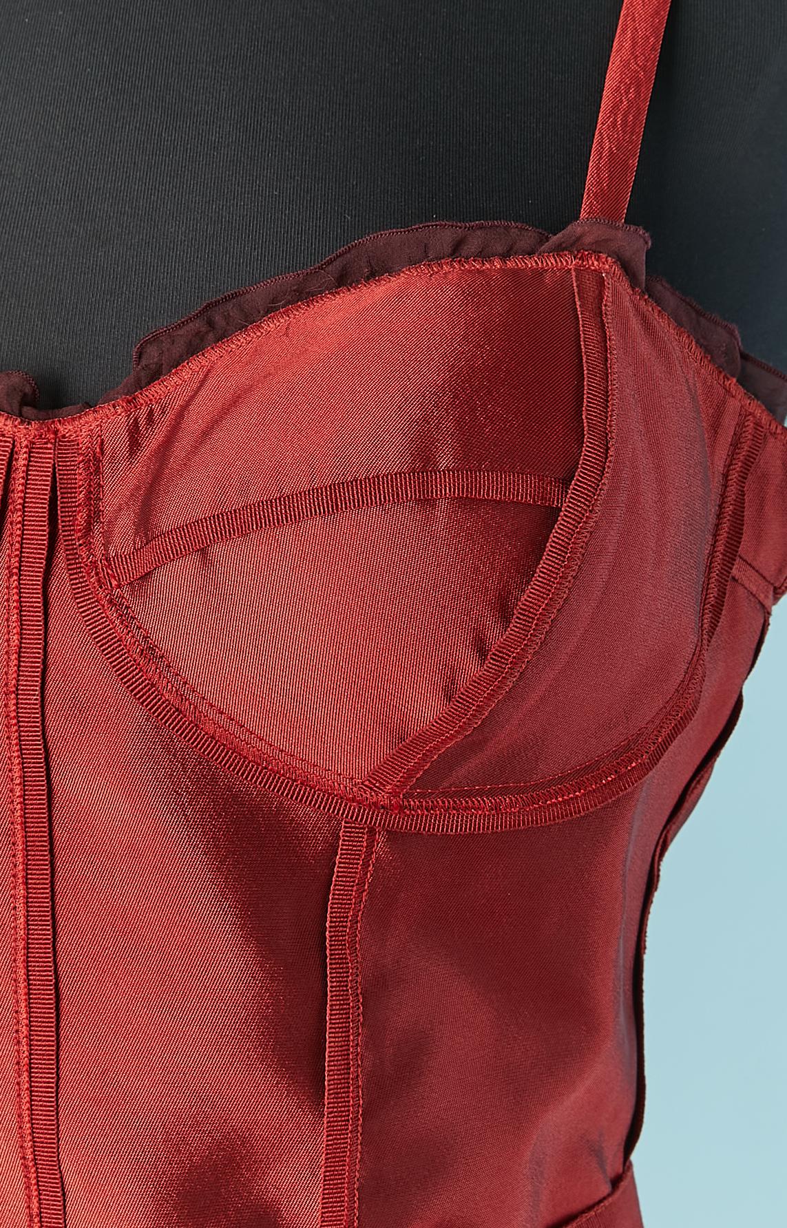 Red bustier cocktail dress. Main fabric composition: 100% silk. Lining composition: 54% acetate, 20% cotton, 10% elastane, 4% spandex, 12% nylon. 
Chiffon ruffles top edge. Gros-grain belt with snap closure on the middle back. 
Boned bustier in