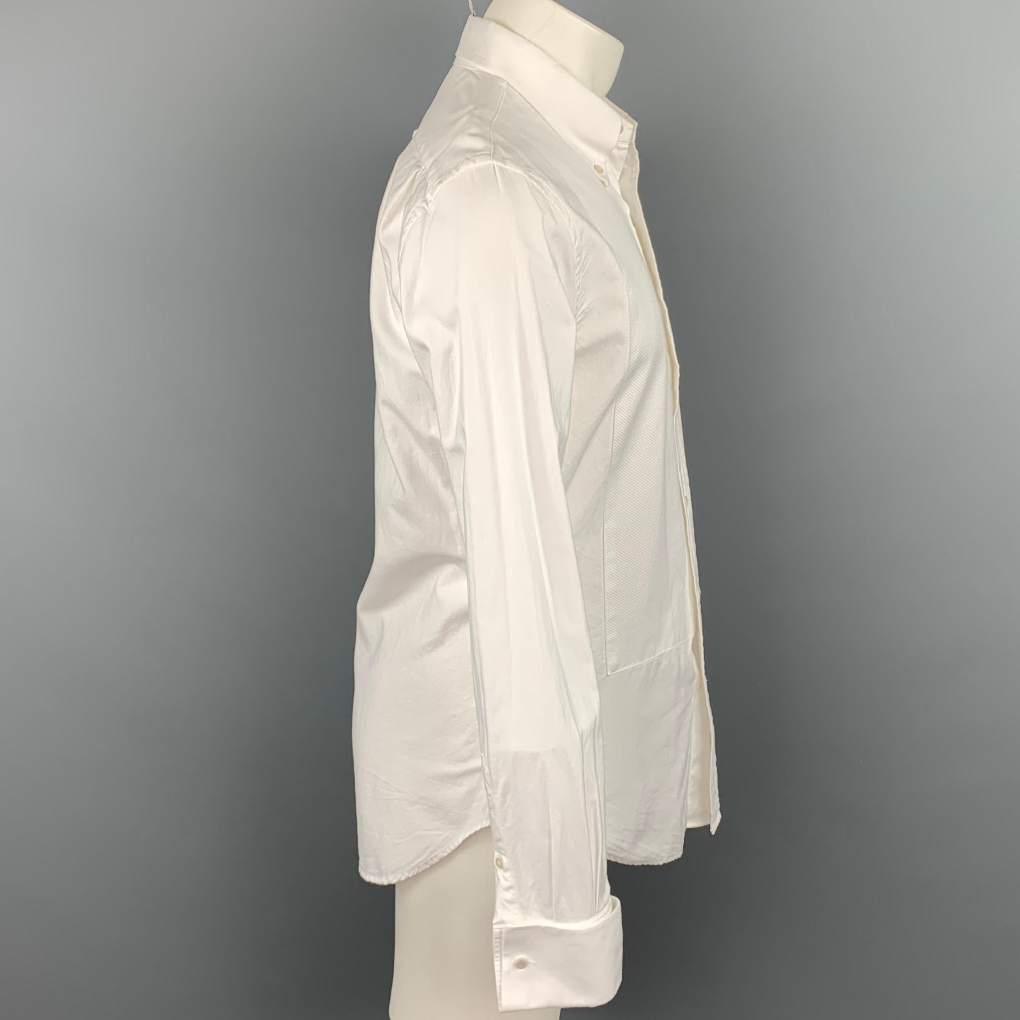 R.E.D. by VALENTINO long sleeve shirt comes in a white textured cotton featuring a front panel design, button down collar, french cuffs, and a buttoned closure. Made in Italy.

Good Pre-Owned Condition.
Marked: IT 50

Measurements:

Shoulder: 18