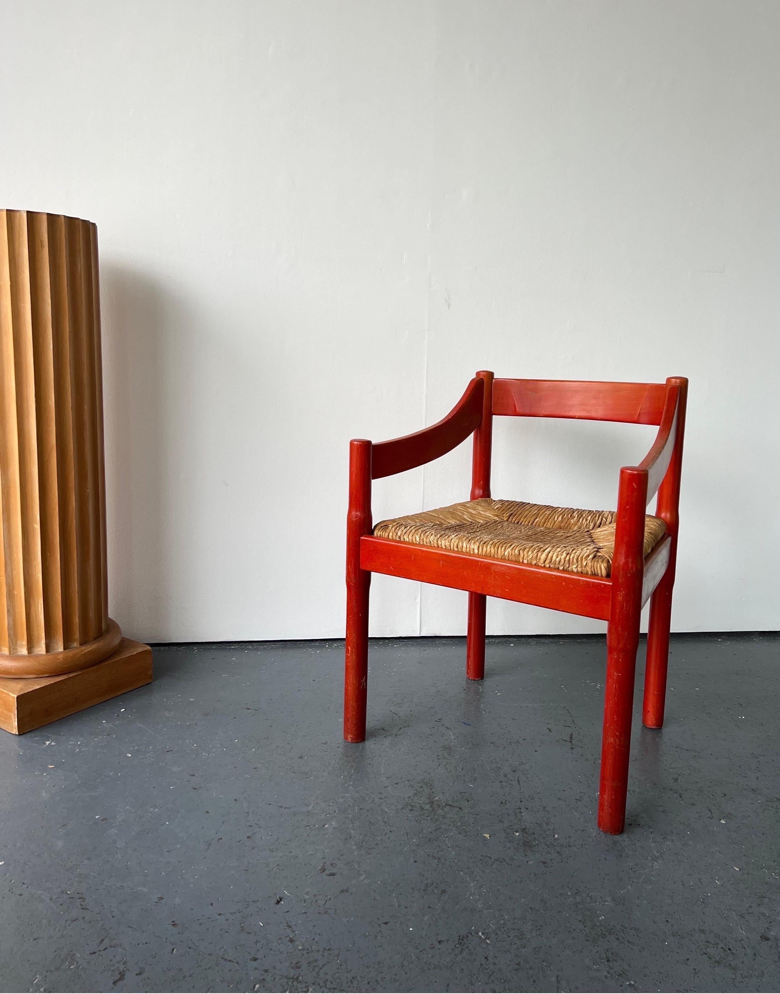 Single Carimate carver chair by designer and architect Vico Magistretti.

Charming original red-stained solid beech Carimate chair designed by architect and designer Vico Magistretti. The chair has the original red stain from the 1960s, the red