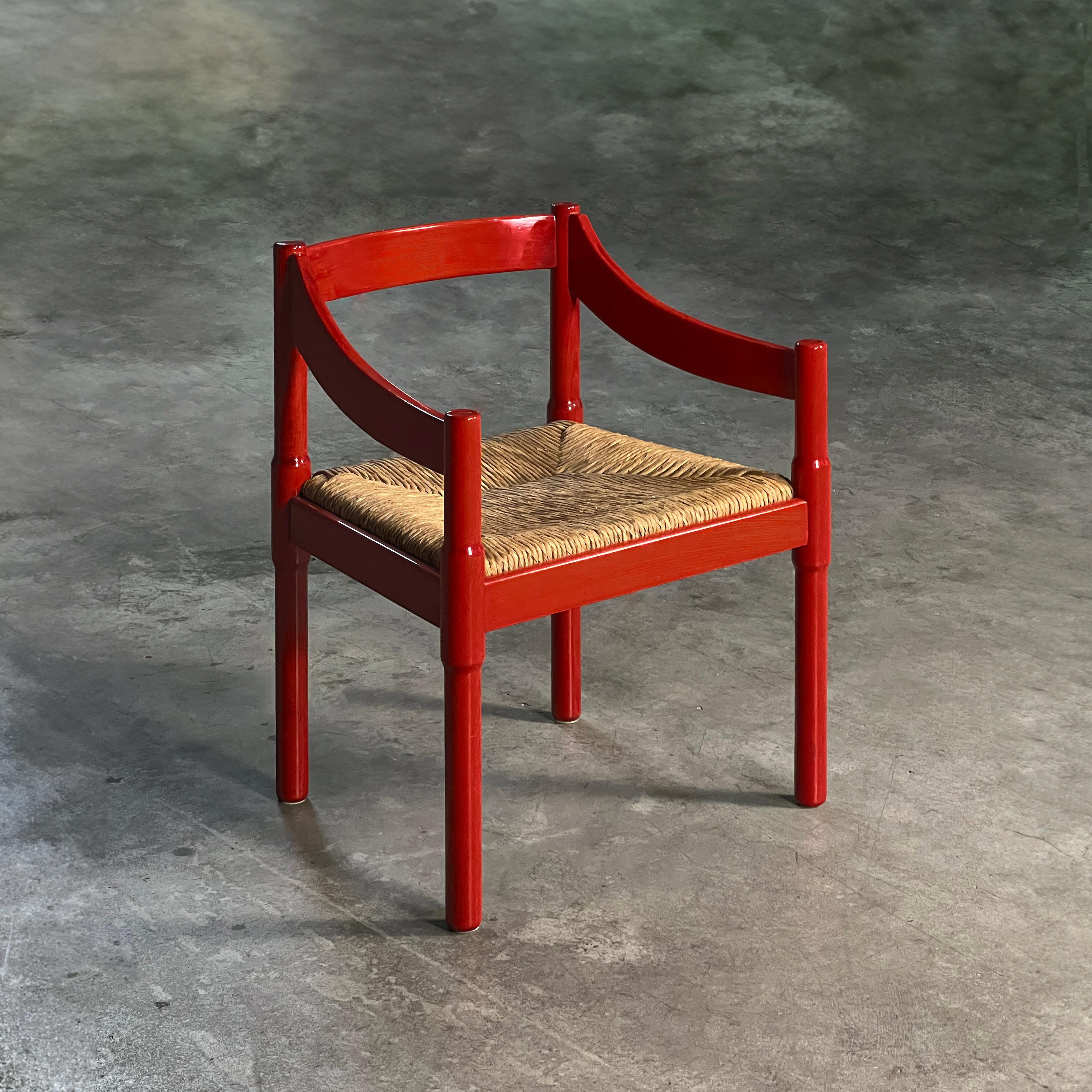 Red Carimate Chair by Vico Magistretti, Italy 1960s

Behold the captivating Carimate chair, a masterpiece carved from rich, red-stained solid beech and brought to life by the visionary architect and designer, Vico Magistretti.

The rush seat, a