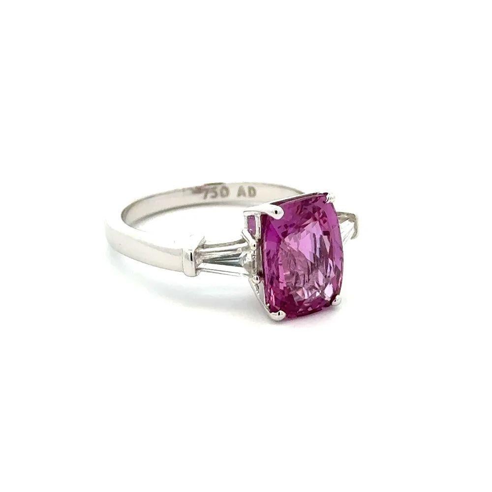 Simply Beautiful! Finely detailed Oscar Worthy Bubble-Gum Pink Sapphire and Baguette Diamond Gold Ring. Centering a securely nestled Hand set Rectangular Cushion Bubble-Gum Pink Sapphire, weighing approx. 3.69 Carats. Hand set with a Tapered