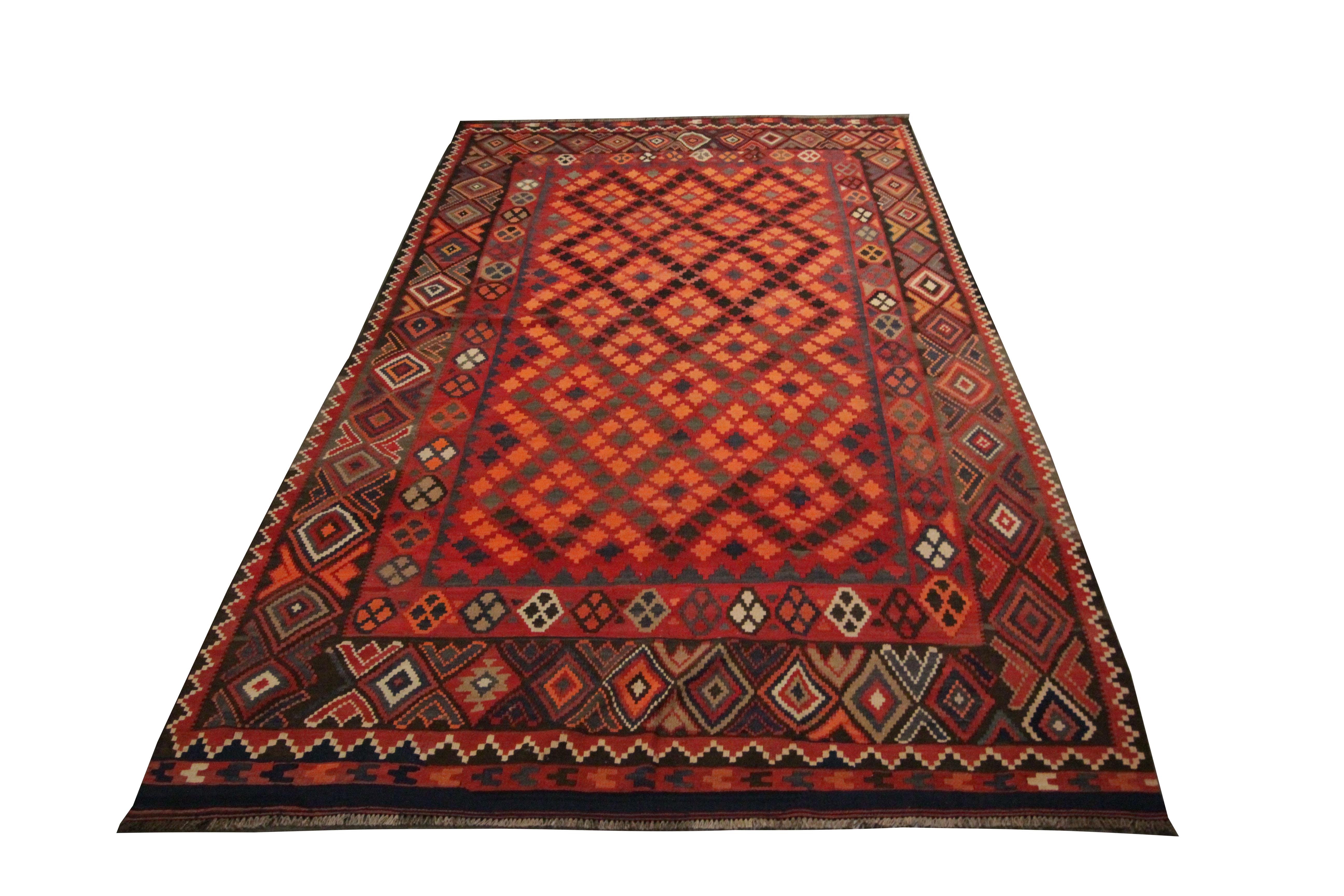 This fine wool rug is a traditional geometric Kilim rug, woven by hand in the late 20th /early 21st century. The design features a bold geometric design with diamond patterns in accents of orange, blue, grey and brown. Woven with fine, hand-spun