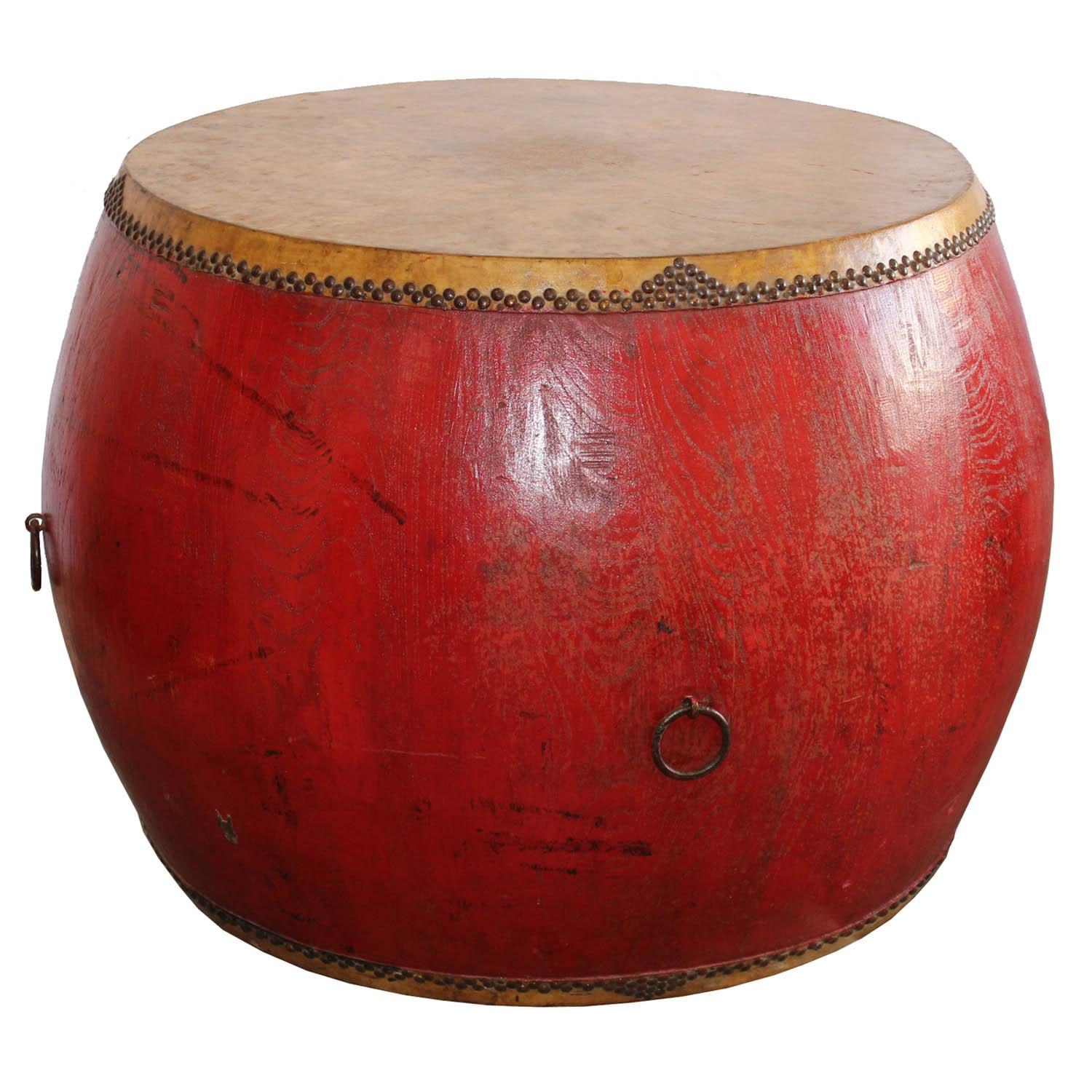 Original vintage drum was used in ceremonies to celebrate various community events. Red lacquer drum with elmwood base and leather covers makes an interesting table.