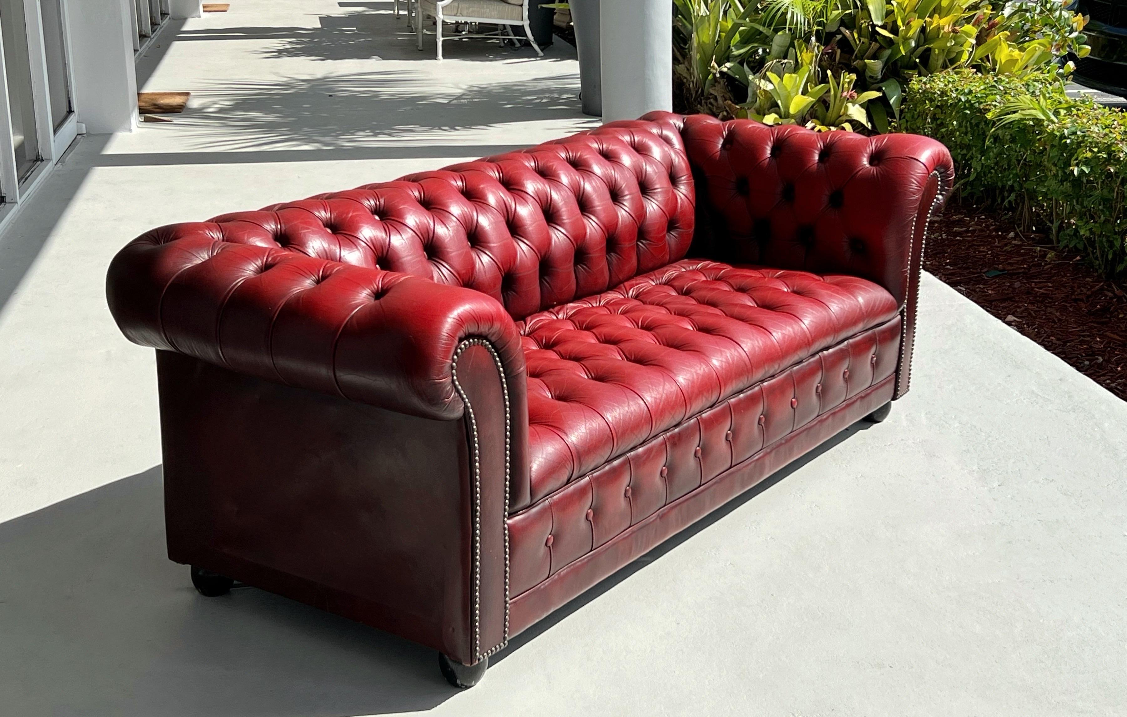 A vintage red leather chesterfield sofa. In very good original condition with that easy on the eye quality that only time and loving care can achieve.