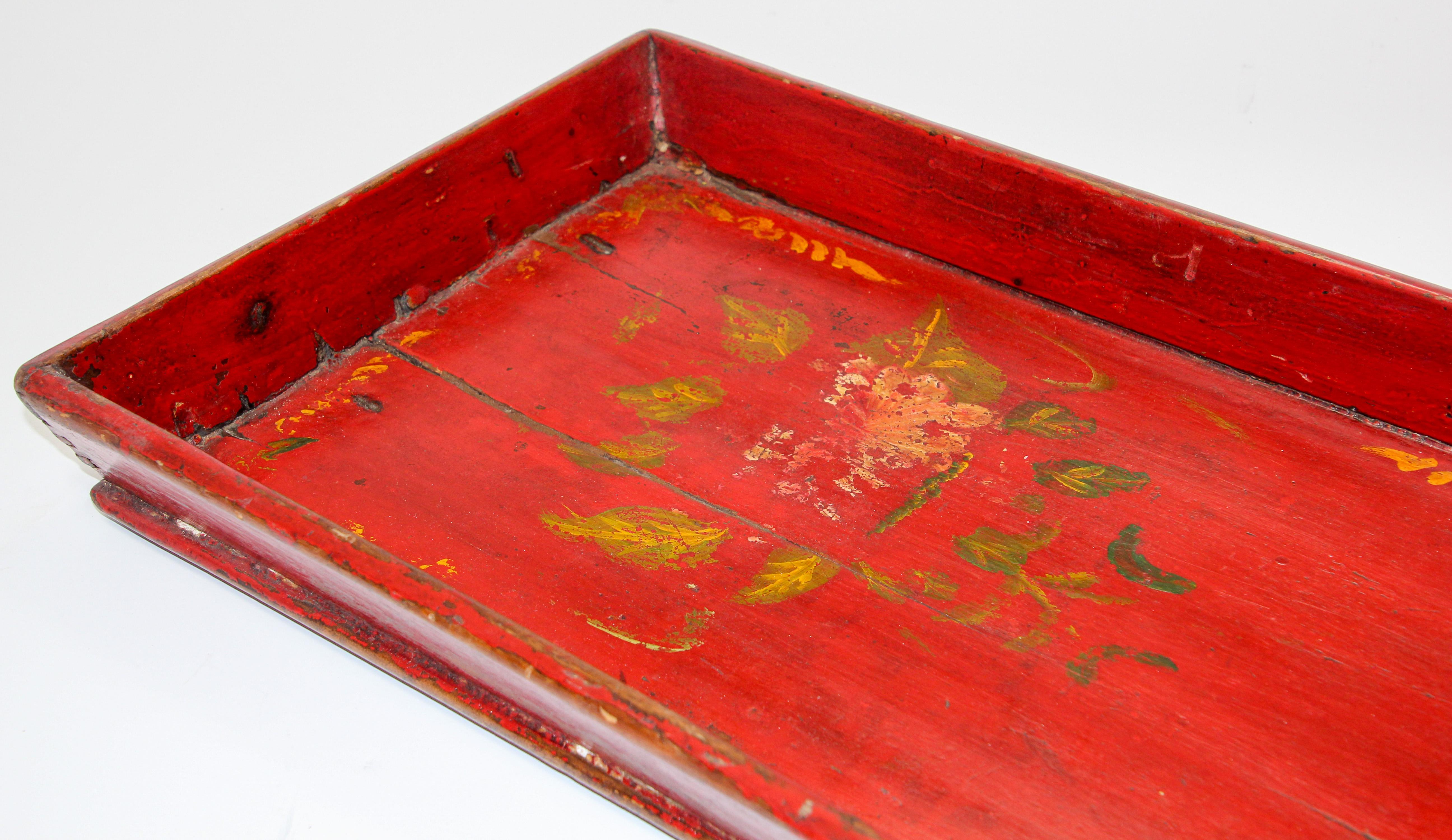 Late 19th century antique wood serving tray hand-painted with flowers on red background.
Worn paint and great patina with floral painted design in red and yellow and green with Chinese calligraphy writing.
Well-constructed and still strong and