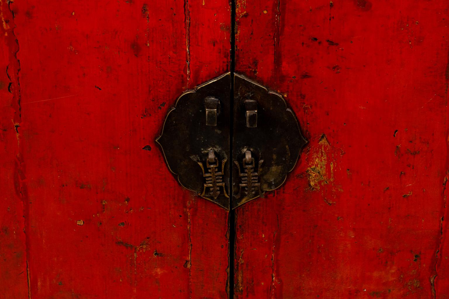 Circa 1890s Chinese commode in a red painted finish with brass hardware. Made in China. Please note of wear consistent with age. Key not included.